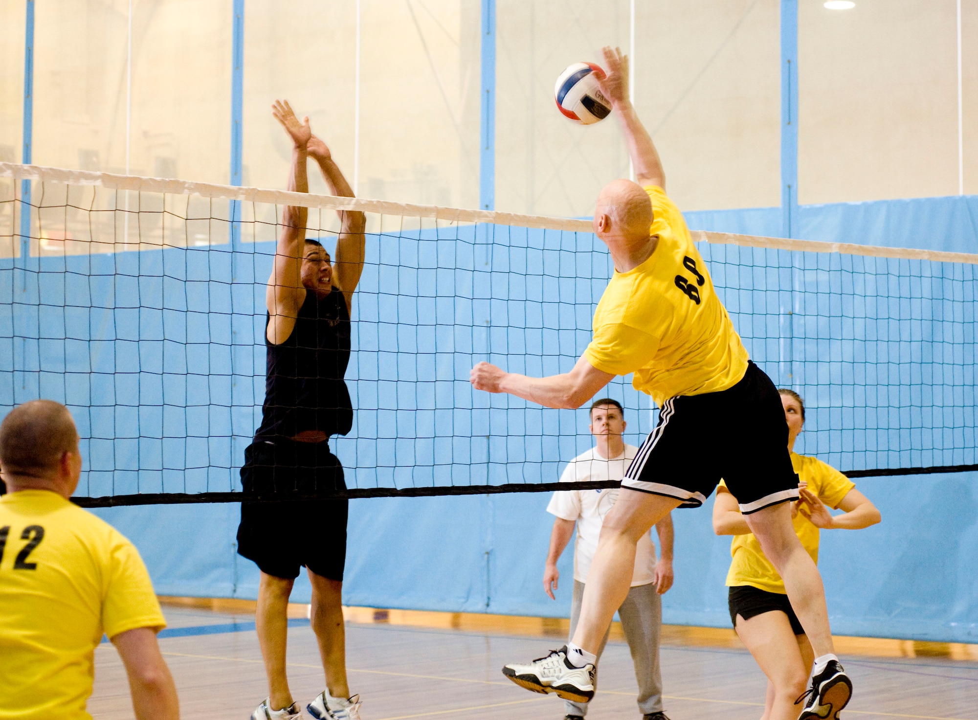 ELMENDORF AIR FORCE BASE, Alaska-- Master Sgt. Rafael Pena-Perez pounds a volleyball into Airman 1st Class Natanael Casas  during a match between  611 Civil Engineer Squadron and the 732 Air Mobility Squadron April 20, 2009. Pena-Perez is from 732 AMS and Casas is from 3 Component Maintenance Squadron playing for 611 CES. The 732 AMS won the match against 611 CES. (U.S. Air Force photo by Senior Airman Jonathan Steffen)  