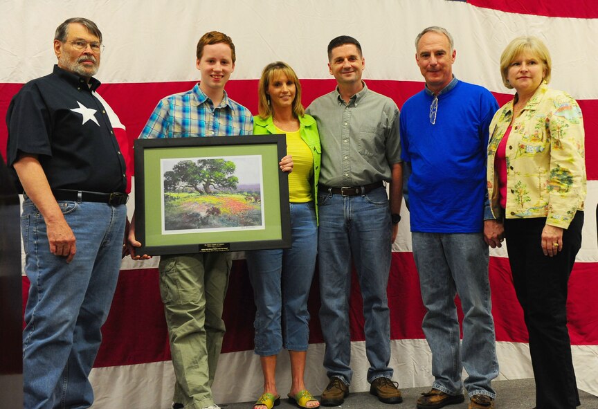 DYESS AIR FORCE BASE, Texas - The Hedden family is presented with the  Military Family of the Year award by Major General Scott III, right, 18th Air Force Commander, during the World?s Largest Barbecue at the Abilene Civic Center, April 18. The World?s Largest Barbeque is sponsored by the Abilene chamber of commerce to show appreciation to active duty members, retired military and military dependents.  (U.S. Air Force photo by Staff Sgt. Connor Estes).  
