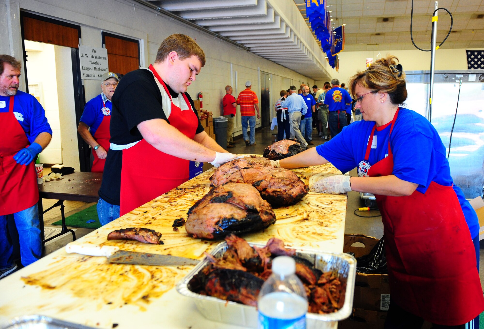 DYESS AIR FORCE BASE, Texas -- Members of the Abilene community nicknamed the ?Dirty Dozen? prepares the meat for the annual World?s Largest Barbecue at the Abilene Civic Center, April 18.  The World?s Largest Barbeque is sponsored by the Abilene chamber of commerce to show appreciation to active duty members, retired military and military dependents.  (U.S. Air Force photo by Staff Sgt. Connor Estes).  