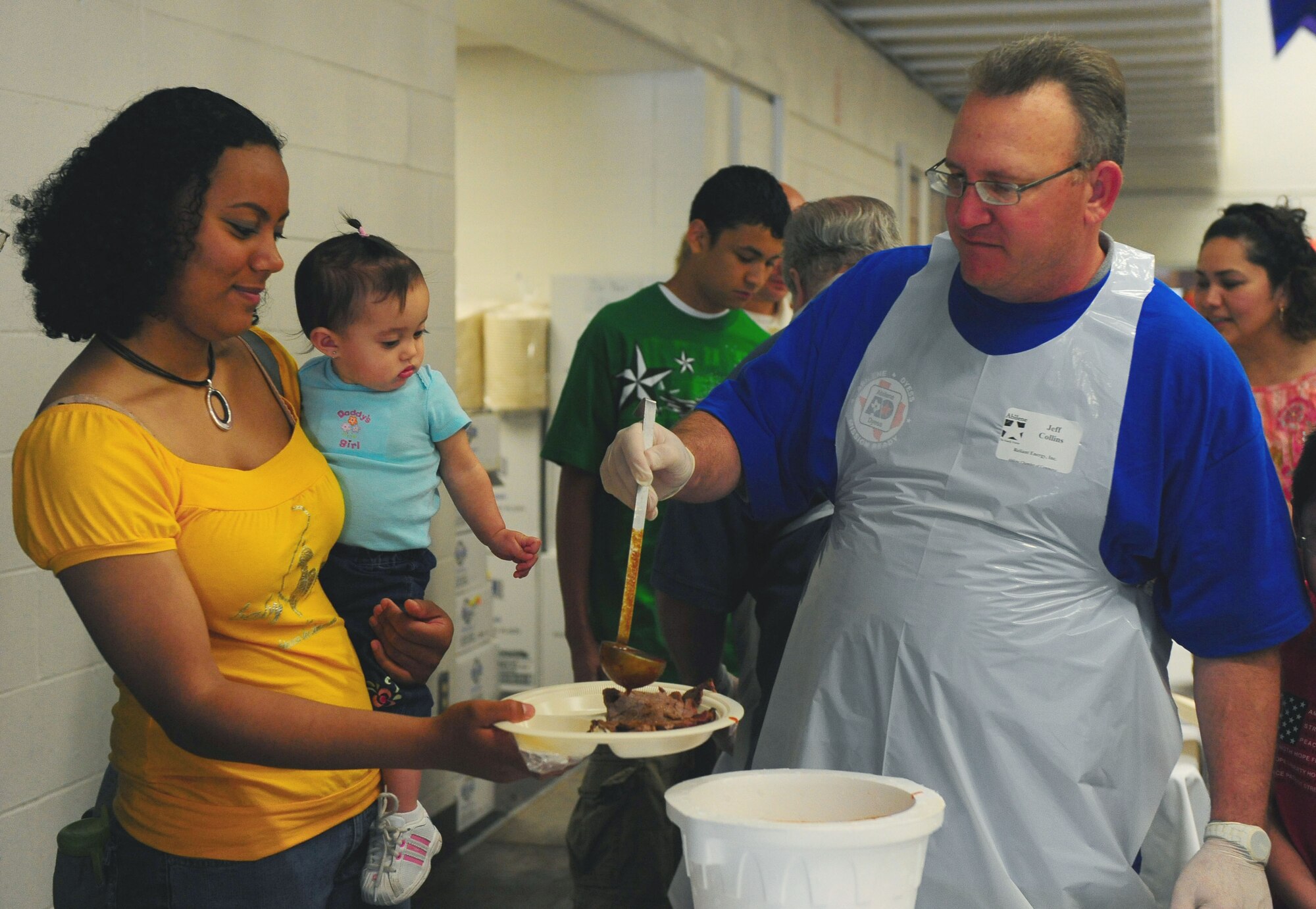 DYESS AIR FORCE BASE, Texas -- Members of the Dyess communityare served a plate of food at the annual World?s Largest Barbecue at the Abilene Civic Center, April 18.  The World?s largest barbeque is sponsored by the Abilene Chamber of Commerce to show appreciation to active duty members, retired military and military dependents.  (U.S. Air Force photo by Staff Sgt. Connor Estes).  