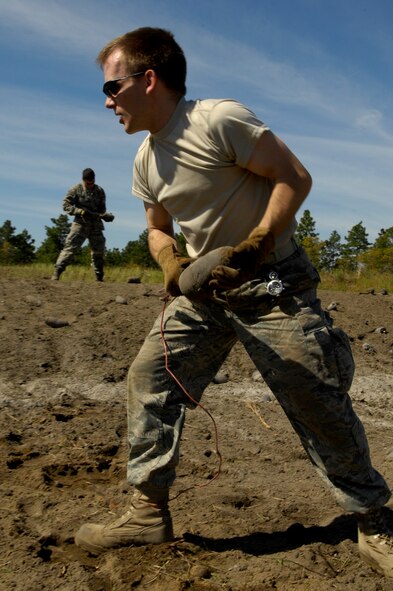 Explosive ordnance disposal technician Staff Sgt. Kenneth Schnorbus carries a bomb dummy unit (BDU) during a range clearance at Poinsett Electronic Combat Range near Shaw AFB, S.C., April 17, 2009.  Shaw F-16 aircraft pilots use the range for target practice. (U.S. Air Force photo by Senior Airman Kathrine McDowell/Released)