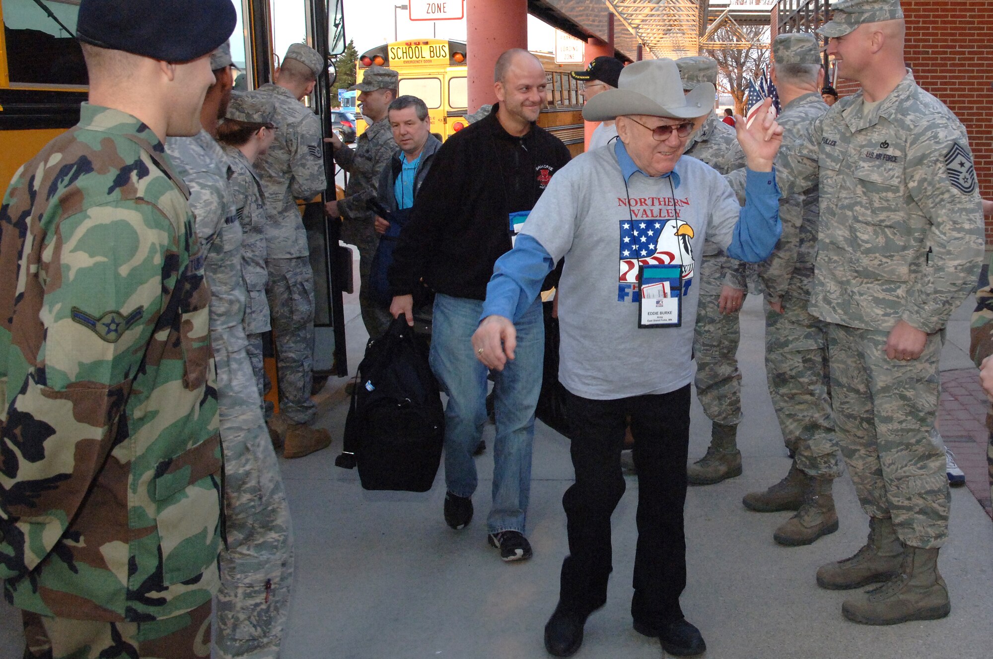 World War II veteran Eddie Burke, East Grand Forks, N.D., is greeted by members of Grand Forks Air Force base as he arrives Grand Forks International Airport on his way to Washington, D.C, as a participant of the Northern Valley Honor Flight April 17. (U.S. Air Force photo/Master Sgt. Paul Cox)