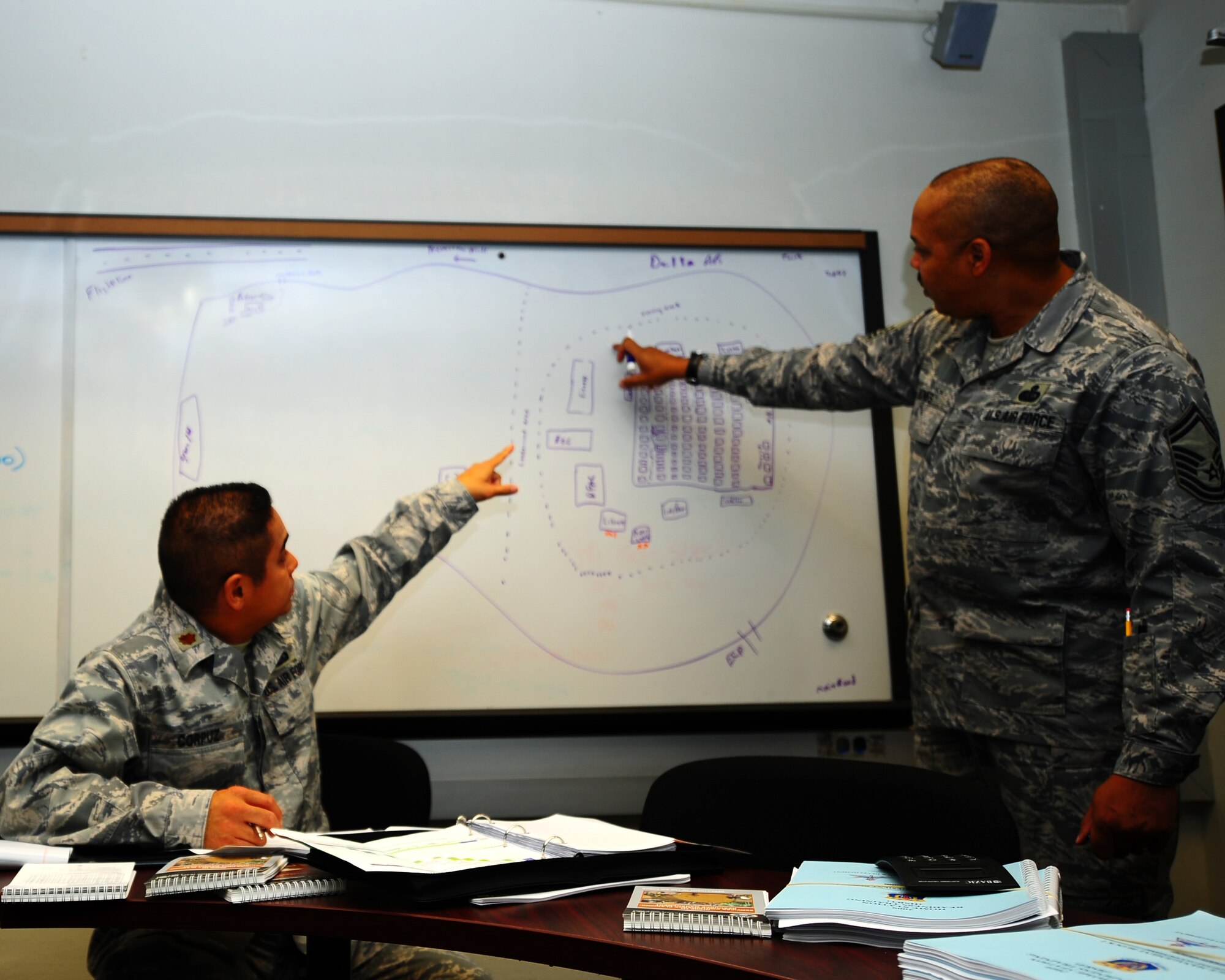DYESS AIR FORCE BASE, Texas - Major Nolan Corpuz, 7th FSS commander, points out the exact location for facilities to Senior Master Sergeant Michael Jones during an exercise here Friday, 17 April.  The exercise was conducted to train both Airman and senior leadership about what to expect if deployed to a bare base location.  (U.S. Air Force photo by SSgt Alan Garrison)