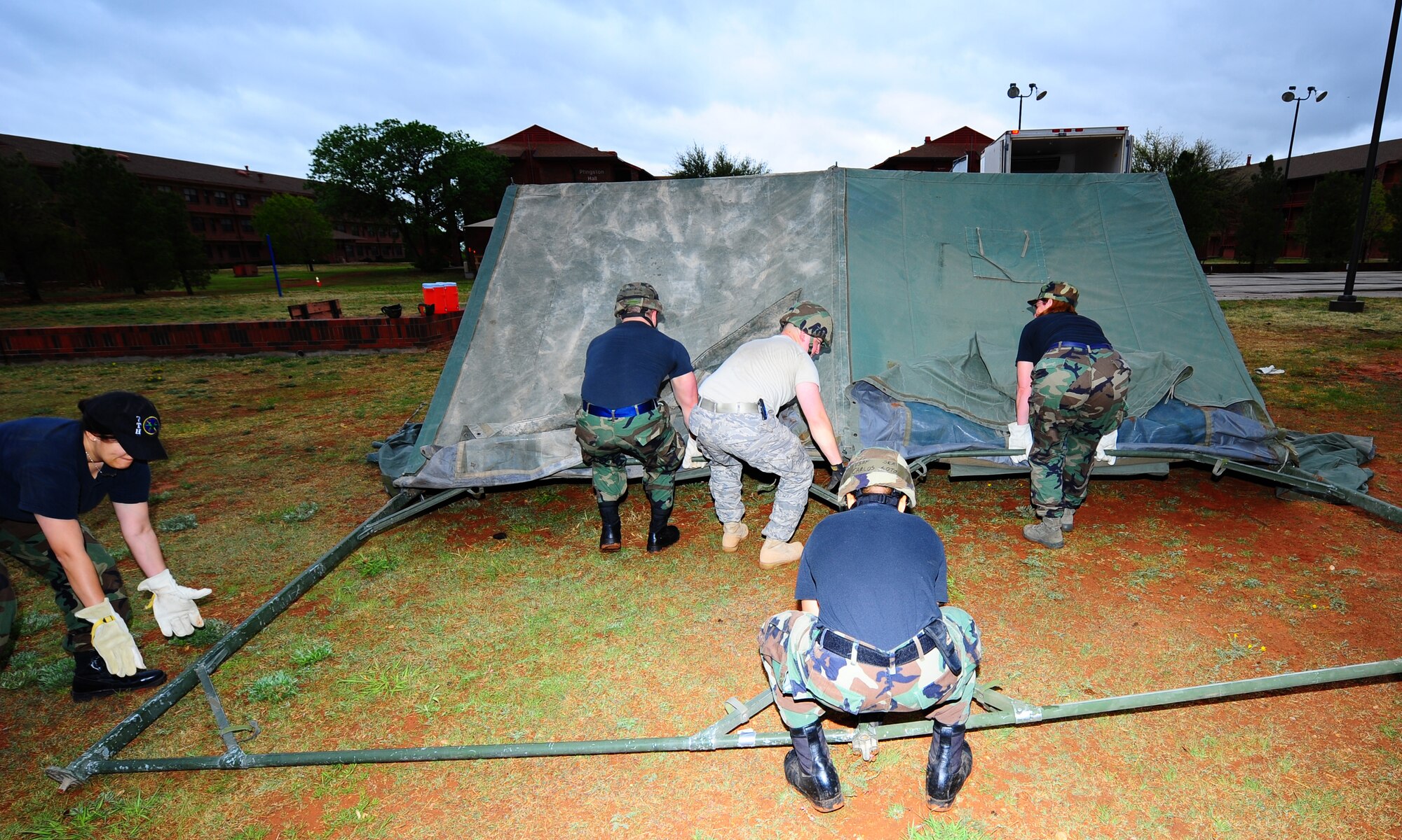 DYESS AIR FORCE BASE, Texas - Airman from the 7th Force Support Squadron erect a tent during an exercise here Friday, 17 April.  The exercise was conducted in order to prepare Airman for the potential of deploying to a bare base location.  (U.S. Air Force photo by SSgt Alan Garrison)