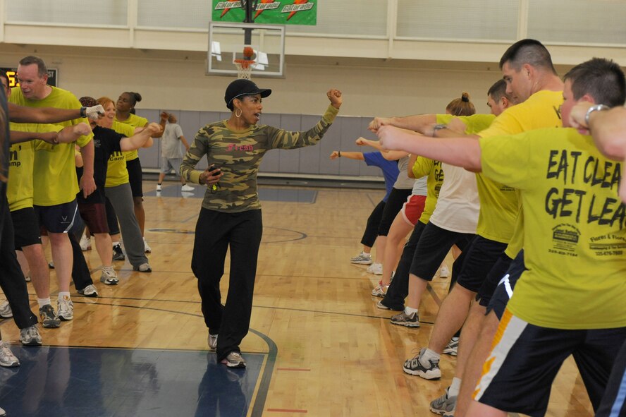 DYESS AIR FORCE BASE, Texas -- Mica Jones, Fit Camp Instructor, tries to get participants of Fit Camp fired up on punching drills here, April 17.  Fit Camp is a 6-week course that teaches people to get serious about fitness and nutrition. (U.S. Air Force photo by Staff Sgt. Connor Estes)    