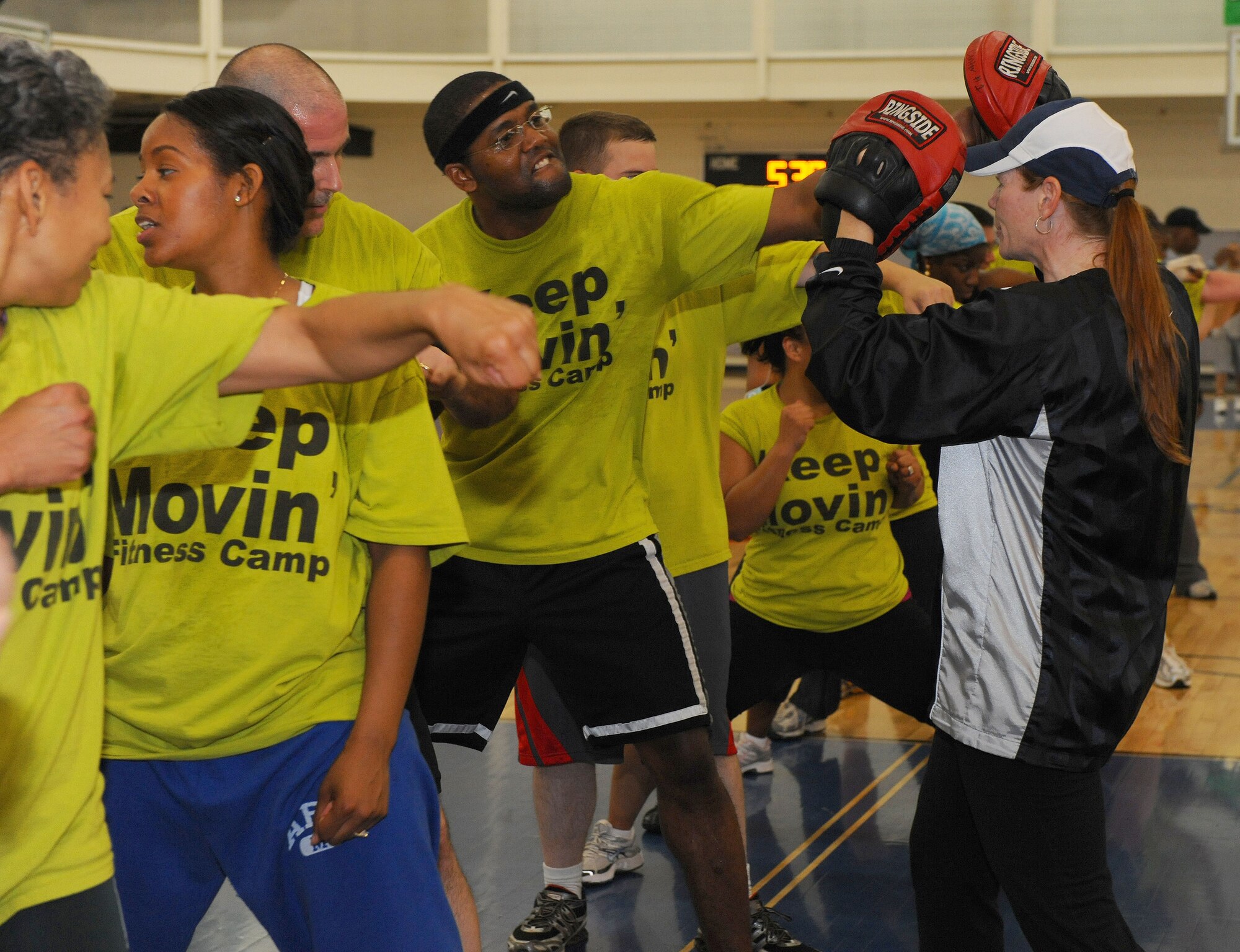 DYESS AIR FORCE BASE, Texas - Kristine Dawson, Fit Camp Instructor, directs participants of Fit Camp on how to punch with attitude here, April 17.  Fit Camp is a 6-week course that teaches people to get serious about fitness and nutrition.  (U.S. Air Force photo by Staff Sgt. Connor Estes).   