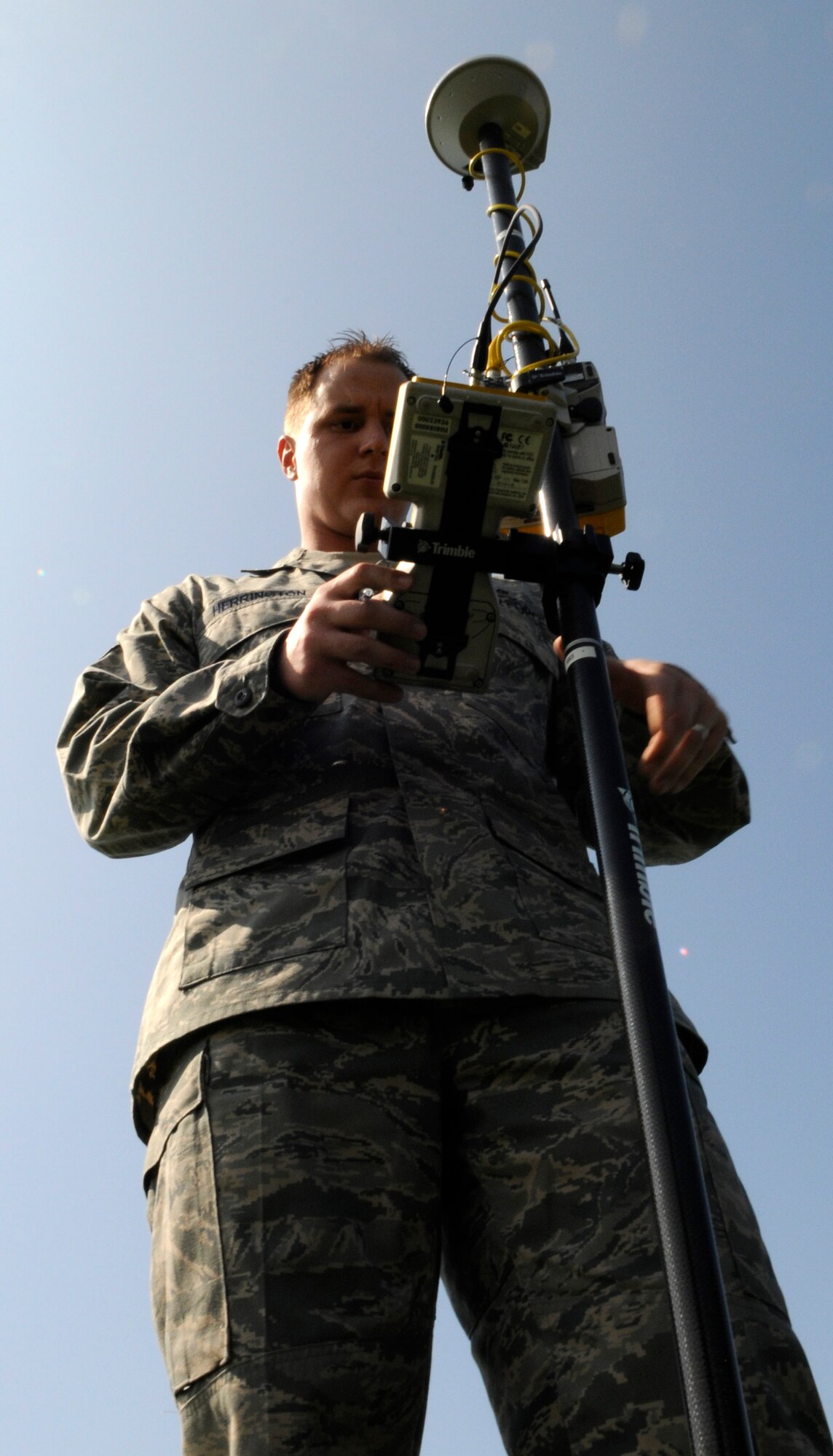 Staff Sgt. Daniel Herrington, 100th Civil Engineer Squadron Geo-Base Technician, reads data on his specialized equipment for a ground survey conducted at RAF Mildenhall, April 21.  Geo-Base provides raw-data, maps, charts and grids for civil engineering projects across the base.  (U.S. Air Force photo by Senior Airman Christopher L. Ingersoll)