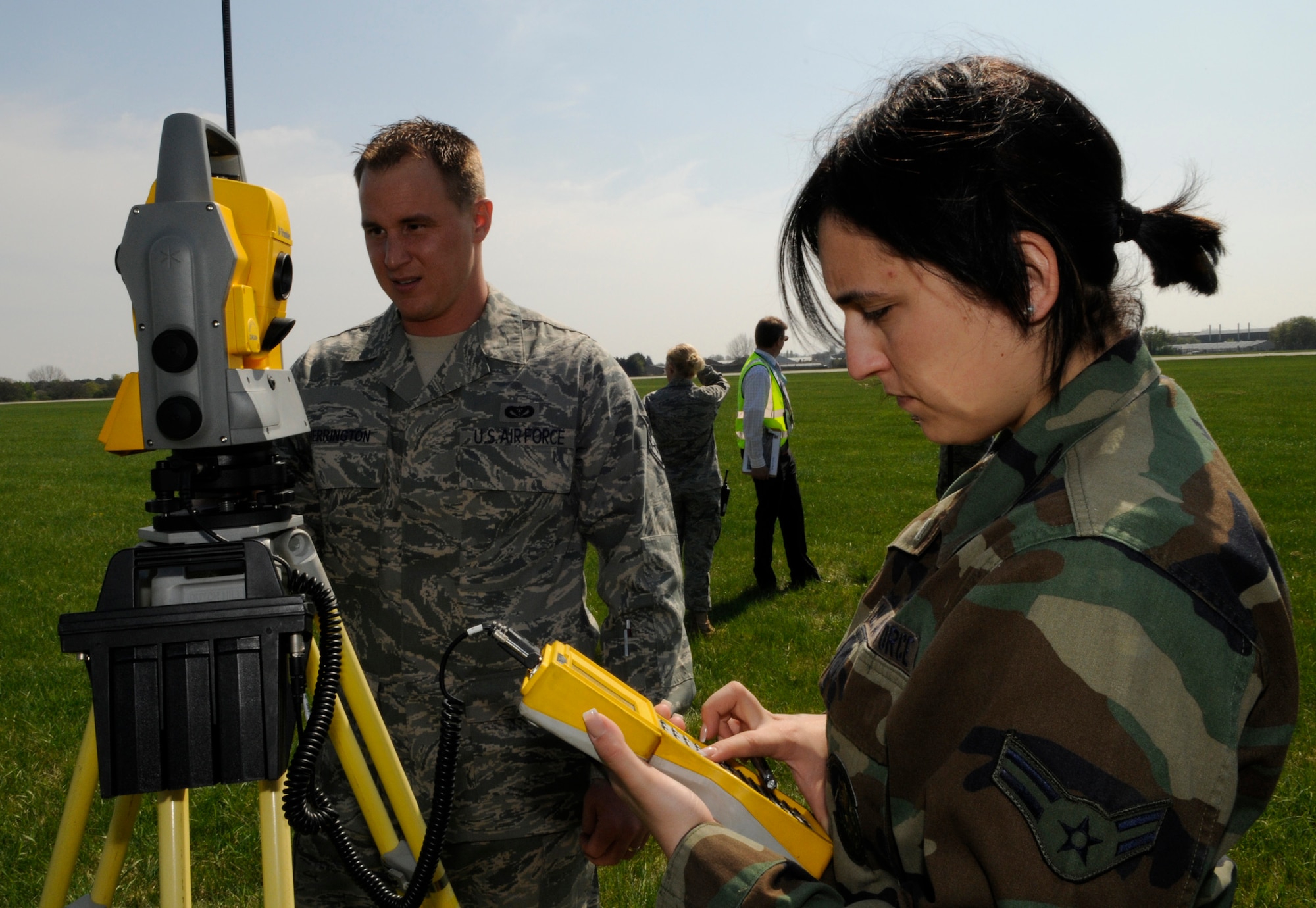 Airman 1st Class Angela Kisiday and Staff Sgt. Daniel Herrington, Geo-Base technicians from the 100th Civil Engineer Squadron, calibrate their equipment before they conduct a grounds survey near the end of the runway at RAF Mildenhall, April 21, 2009.  