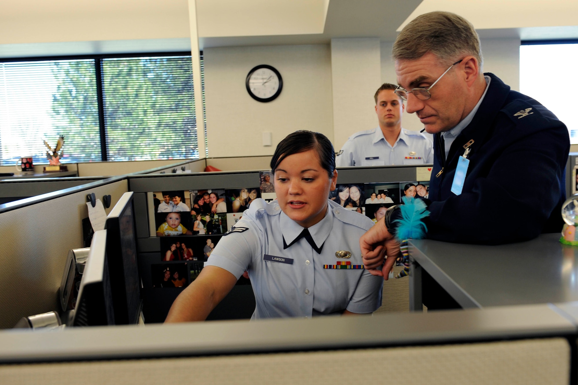 (Right) Col. Joseph S. Ward Jr., Air Force Material Command Financial Management  director, watches the steps of completing a separation and retirement final pay completion form by Airman 1st Class Brittney Lawson, Air Force Financial Services Center separation and retirements technician, here, April 20. The AFFSC centrally processes all military pay, travel pay and transactions for the Air Force. (U.S. Air Force photo by Airman First Class Corey Hook)