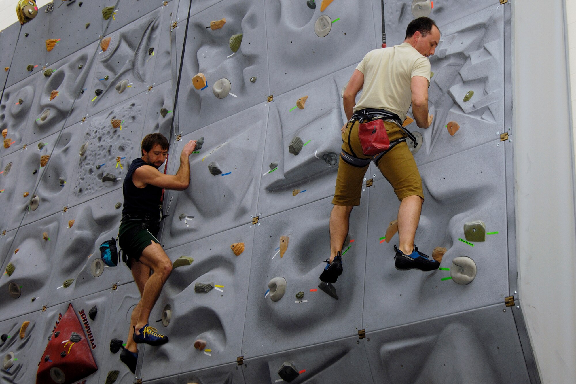 Misha Ivanov of Lincoln Lab and Capt. James Scoville, Air Force Research Laboratory, ascend the rock climbing wall at Hanscom’s Fitness Center April 17.  Rock climbing classes at the Fitness Center are one of several increasingly popular ways for civilians, and all Hanscom ID holders, to keep fit. (U.S. Air Force photo by Linda LaBonte-Britt) 