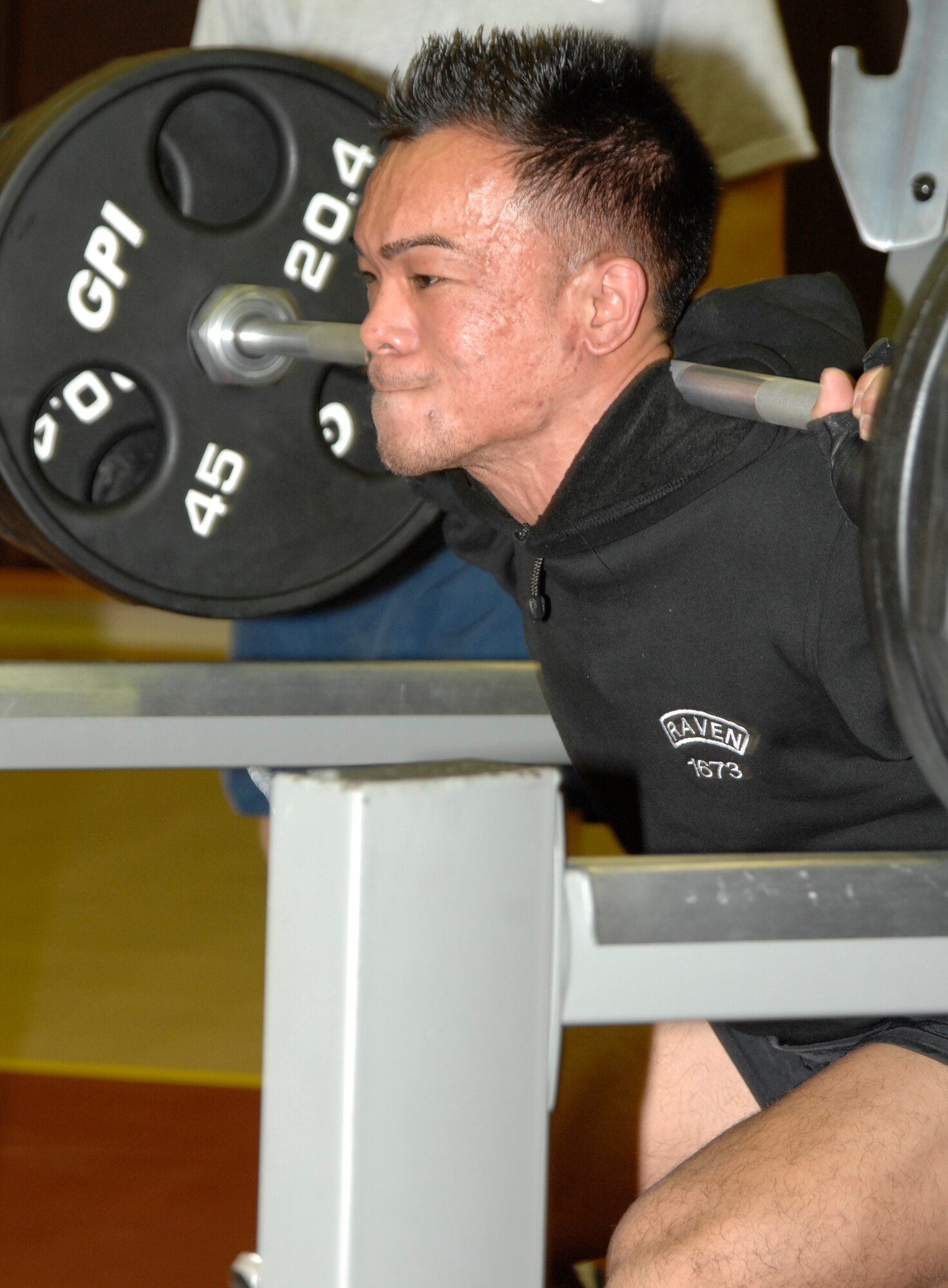 Senior Airman Franz Enriquez, 817 Expeditionary Airlift Squadron, struggles to squat a set amount of weight while competing in the 39th Force Support Squadron’s first power-lifting competition at the Incirlik Fitness center, April 18, 2009. Airman Enriquez lifted a total weight of 995 lbs., spanning squats, dead lifts and bench presses, giving him a score of 708.937 on the Glossbrenner scale. The Glossbrenner Scale multiplies the total weight lifted by a body weight coefficient to even the playing field between all contestants. Staff Sgt. Shaun Crum, 39th Communications Squadron, was awarded 1st place with a total weight of 1,285 lbs. and a score of 792.138. (U.S. Air Force photo/Senior Airman Benjamin Wilson)