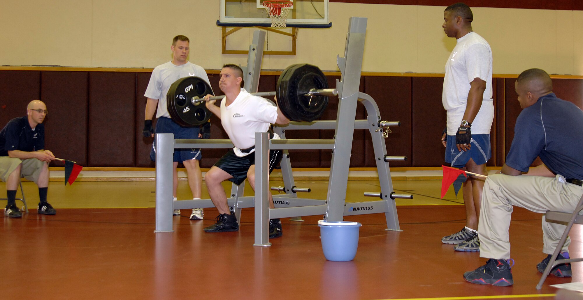 Staff Sgt. Shaun Crum, 39th Communications Squadron, struggles during his third squat attempt while competing in the 39th Force Support Squadron’s first power-lifting competition at the Incirlik Fitness center, April 18, 2009. Sergeant Crum  lifted a total weight of 1,285 lbs., spanning squats, dead lifts and bench presses, giving him a score of 792.138 on the Glossbrenner scale, earning first place in the competition. The Glossbrenner Scale multiplies the total weight lifted by a body weight coefficient to even the playing field between all contestants. (U.S. Air Force photo/Senior Airman Benjamin Wilson)