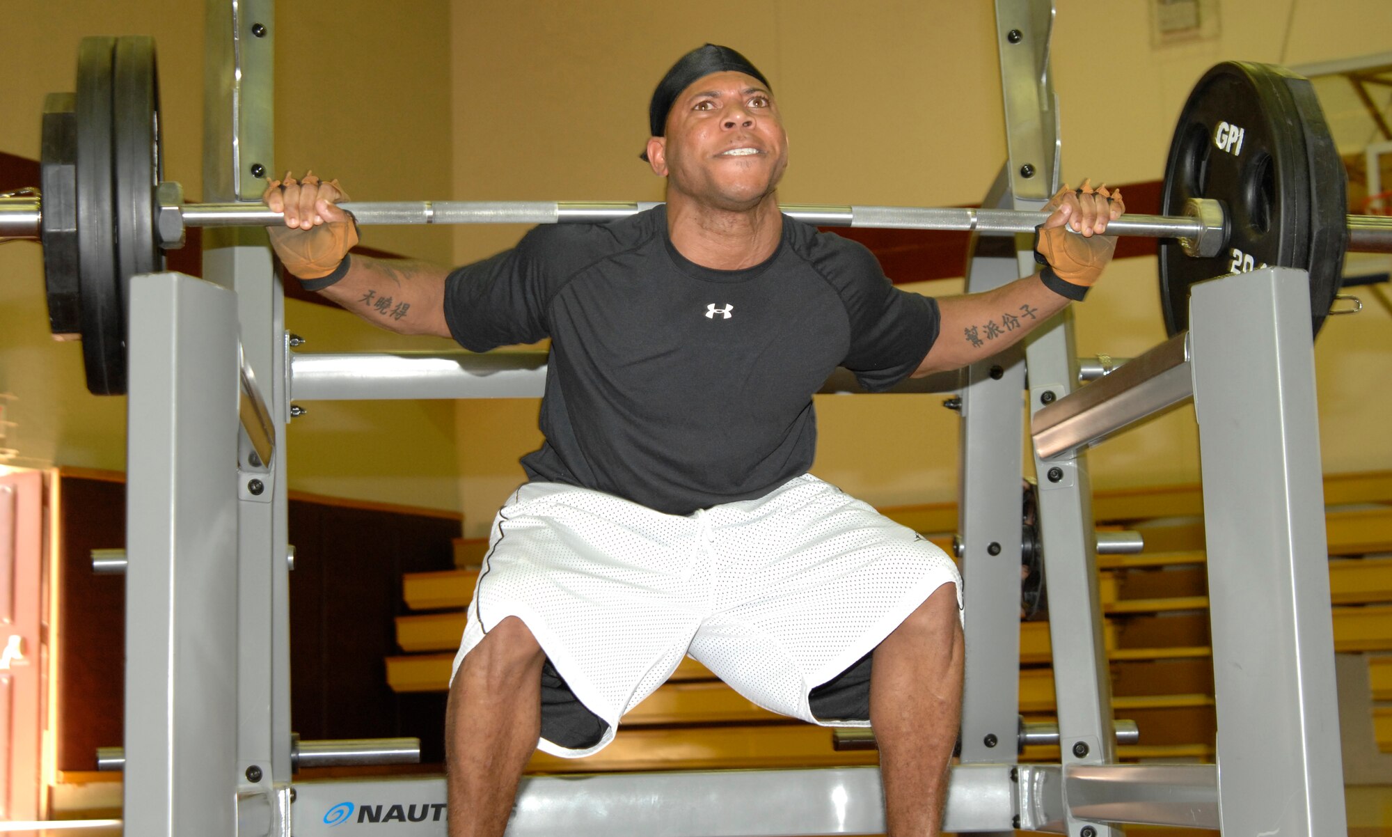 Senior Airman Zaccaria Smith, 39th Logistics Support Squadron, struggles to squat a set amount of weight while competing in the 39th Force Support Squadron’s first power-lifting competition at the Incirlik Fitness center, April 18, 2009. Airman Smith lifted a total weight of 950 lbs., spanning squats, dead lifts and bench presses, giving him a score of 682.907 on the Glossbrenner scale. The Glossbrenner Scale multiplies the total weight lifted by a body weight coefficient to even the playing field between all contestants. Staff Sgt. Shaun Crum, 39th Communications Squadron, was awarded 1st place with a total weight of 1,285 lbs. and a score of 792.138. (U.S. Air Force photo/Senior Airman Benjamin Wilson)