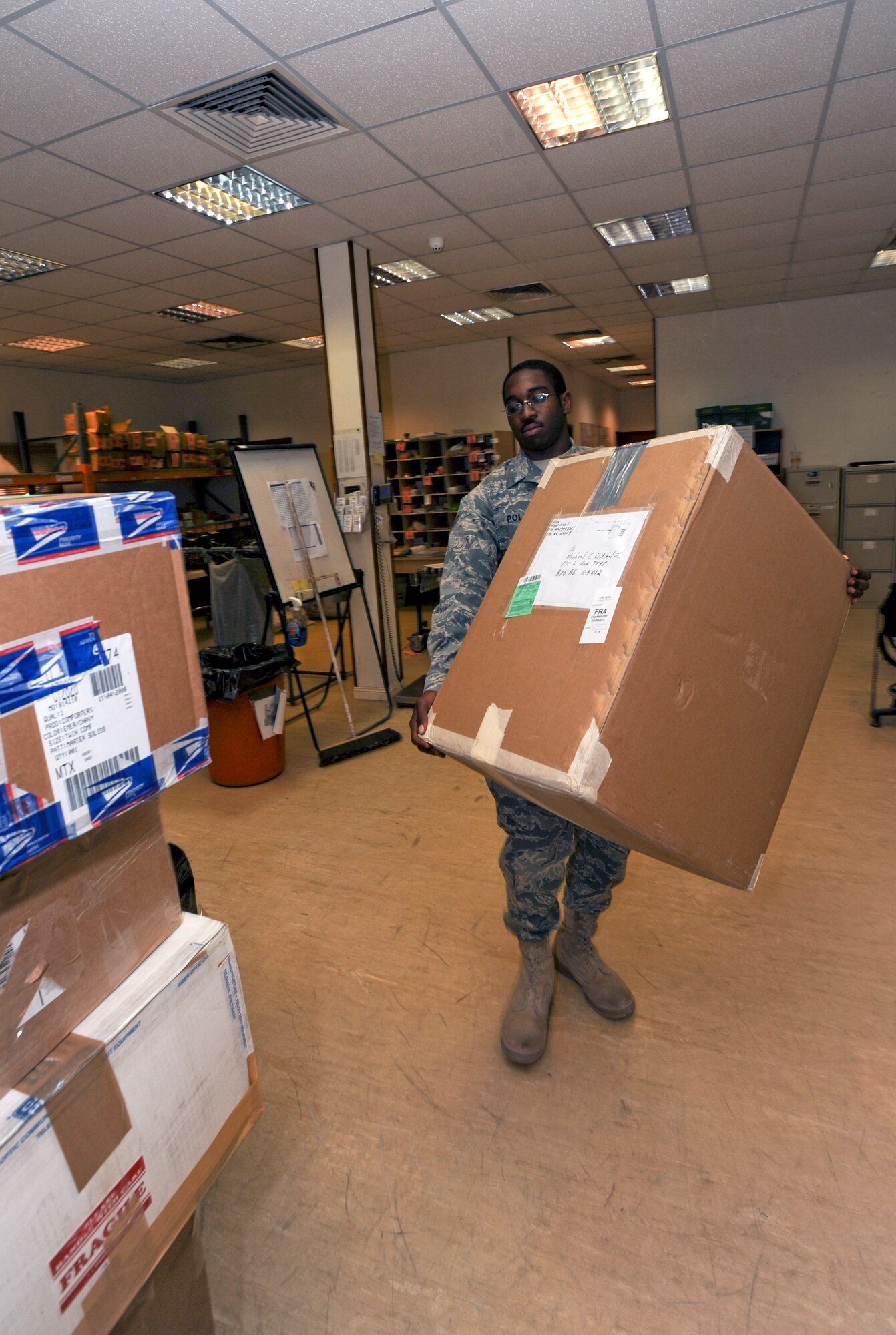 Airman 1st Class Cardell Polk, a postal clerk with the 379th Expeditionary Communication Squadron, stages packages to be picked up later in the day here, April 20, 2009, in an undisclosed location in Southwest Asia.  Throughout the day outgoing mail is prepped for transport to the airport for further delivery.  Airman Polk is native to New Orleans, La. and is deployed from Pope Air Force Base, N.C. in support of Operations Iraqi and Enduring Freedom, and Combined Joint Task Force - Horn of Africa.  (U.S. Air Force Photo by Staff Sgt. Joshua Garcia/released)