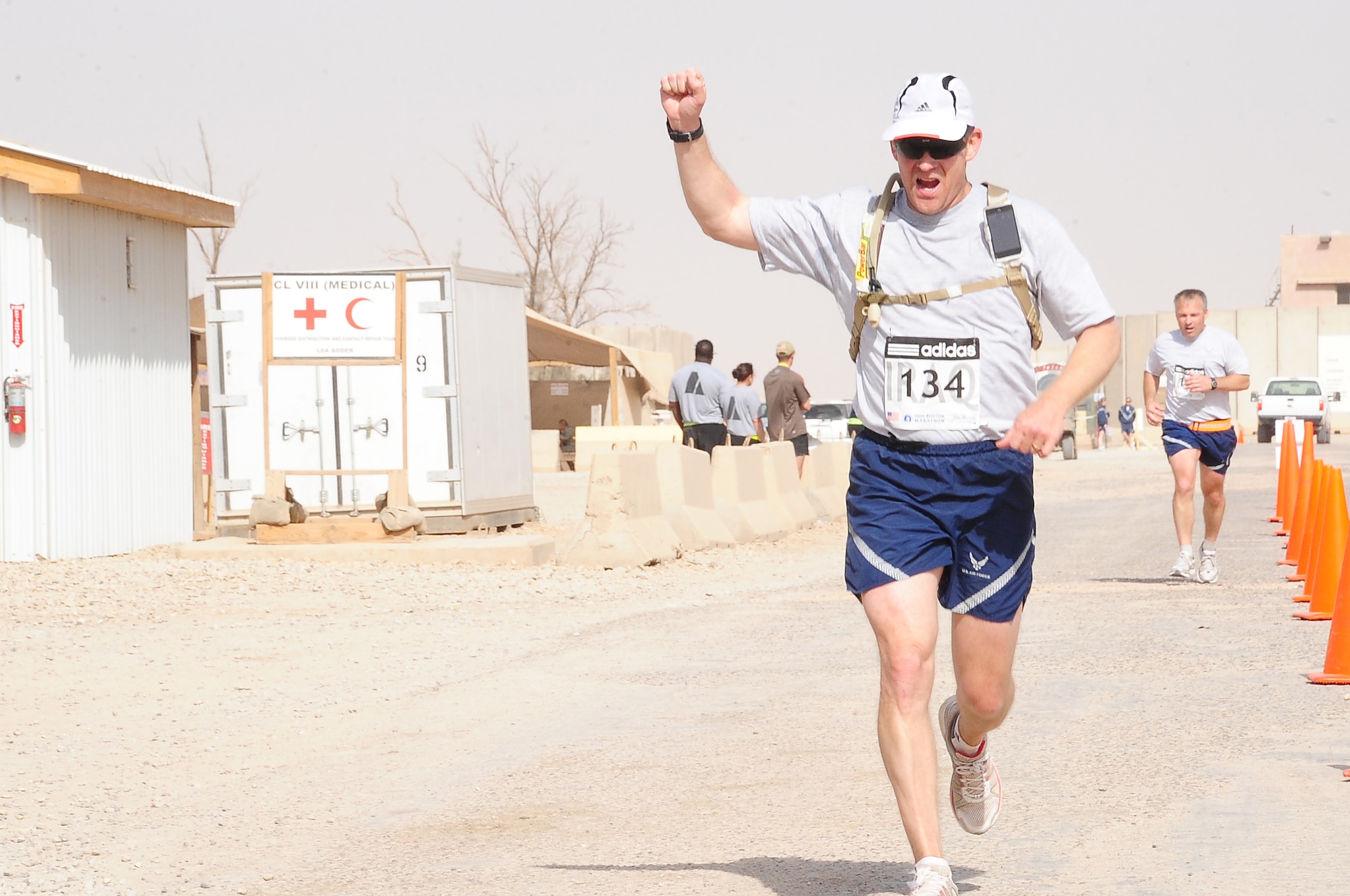 ALI BASE, Iraq – Airmen here run across the finish line during the Boston Marathon held at Contingency Operating Base Adder April 18.  This is the fifth year the marathon has been run at COB Adder. Service members with qualifying times this year will be able to run in Boston at next year’s race.  (U.S. Air Force photo/Staff Sgt. Christopher Marasky)