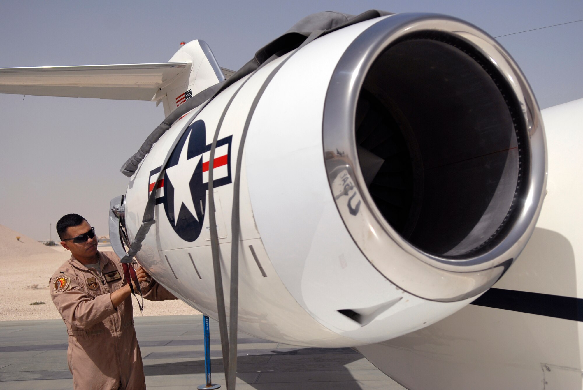 1st Lt. Luis Garces, a 379th Expeditionary Operations Group C-21 Pilot, removes an engine cover during a routine pre-flight inspection on a USAF C-21 aircraft, Apr. 15, 2009, at an undisclosed location in Southwest Asia.  The C-21 is an operational support airlift aircraft for transporting personnel and provides emergency medical evacuation transport if needed within the U.S. Central Command's Area of Responsibility.  Lt. Garces hails from Queens, N.Y. and is deployed from Scott Air Force Base, Ill. in support of Operations Iraqi and Enduring Freedom and Combined Joint Task Force - Horn of Africa.  (U.S. Air Force photo/Senior Airman Andrew Satran/released)