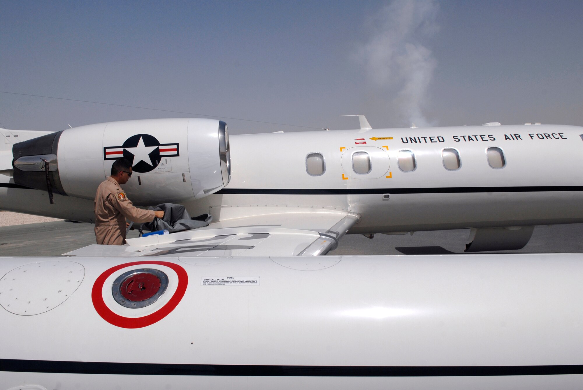 1st Lt. Luis Garces, a 379th Expeditionary Operations Group C-21 Pilot, removes an engine cover during a routine pre-flight inspection on a USAF C-21 aircraft, Apr. 15, 2009, at an undisclosed location in Southwest Asia.  The C-21 is an operational support airlift aircraft for transporting personnel and provides emergency medical evacuation transport if needed within the U.S. Central Command's Area of Responsibility.  Lt. Garces hails from Queens, N.Y. and is deployed from Scott Air Force Base, Ill. in support of Operations Iraqi and Enduring Freedom and Combined Joint Task Force - Horn of Africa.  (U.S. Air Force photo/Senior Airman Andrew Satran/released)