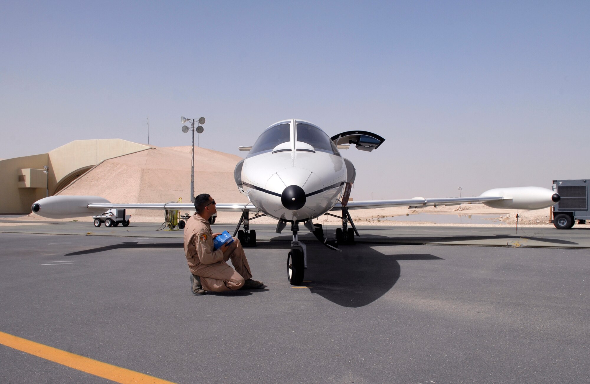 1st Lt. Luis Garces, a 379th Expeditionary Operations Group C-21 Pilot, performs a pre-flight inspection on a USAF C-21 aircraft, Apr. 15, 2009, at an undisclosed location in Southwest Asia.  The C-21 is an operational support airlift aircraft for transporting personnel and provides emergency medical evacuation transport if needed within the U.S. Central Command's Area of Responsibility.  Lt. Garces hails from Queens, N.Y. and is deployed from Scott Air Force Base, Ill. in support of Operations Iraqi and Enduring Freedom and Combined Joint Task Force - Horn of Africa.  (U.S. Air Force photo/Senior Airman Andrew Satran/released)