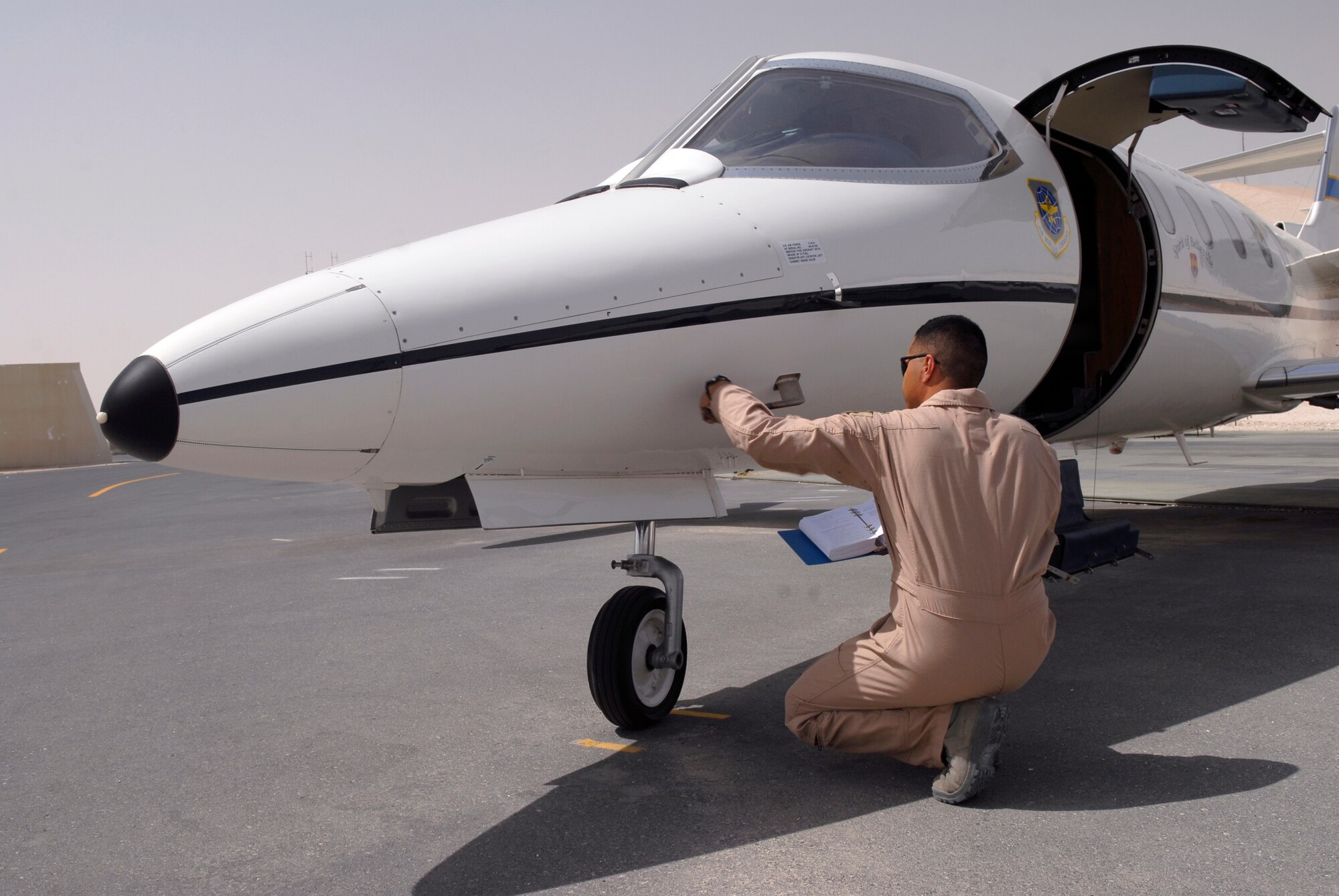 1st Lt. Luis Garces, a 379th Expeditionary Operations Group C-21 Pilot, removes a pitot tube cover during a routine pre-flight inspection on a USAF C-21 aircraft, Apr. 15, 2009, at an undisclosed location in Southwest Asia.  The C-21 is an operational support airlift aircraft for transporting personnel and provides emergency medical evacuation transport if needed within the U.S. Central Command's Area of Responsibility.  Lt. Garces hails from Queens, N.Y. and is deployed from Scott Air Force Base, Ill. in support of Operations Iraqi and Enduring Freedom and Combined Joint Task Force - Horn of Africa.  (U.S. Air Force photo/Senior Airman Andrew Satran/released)