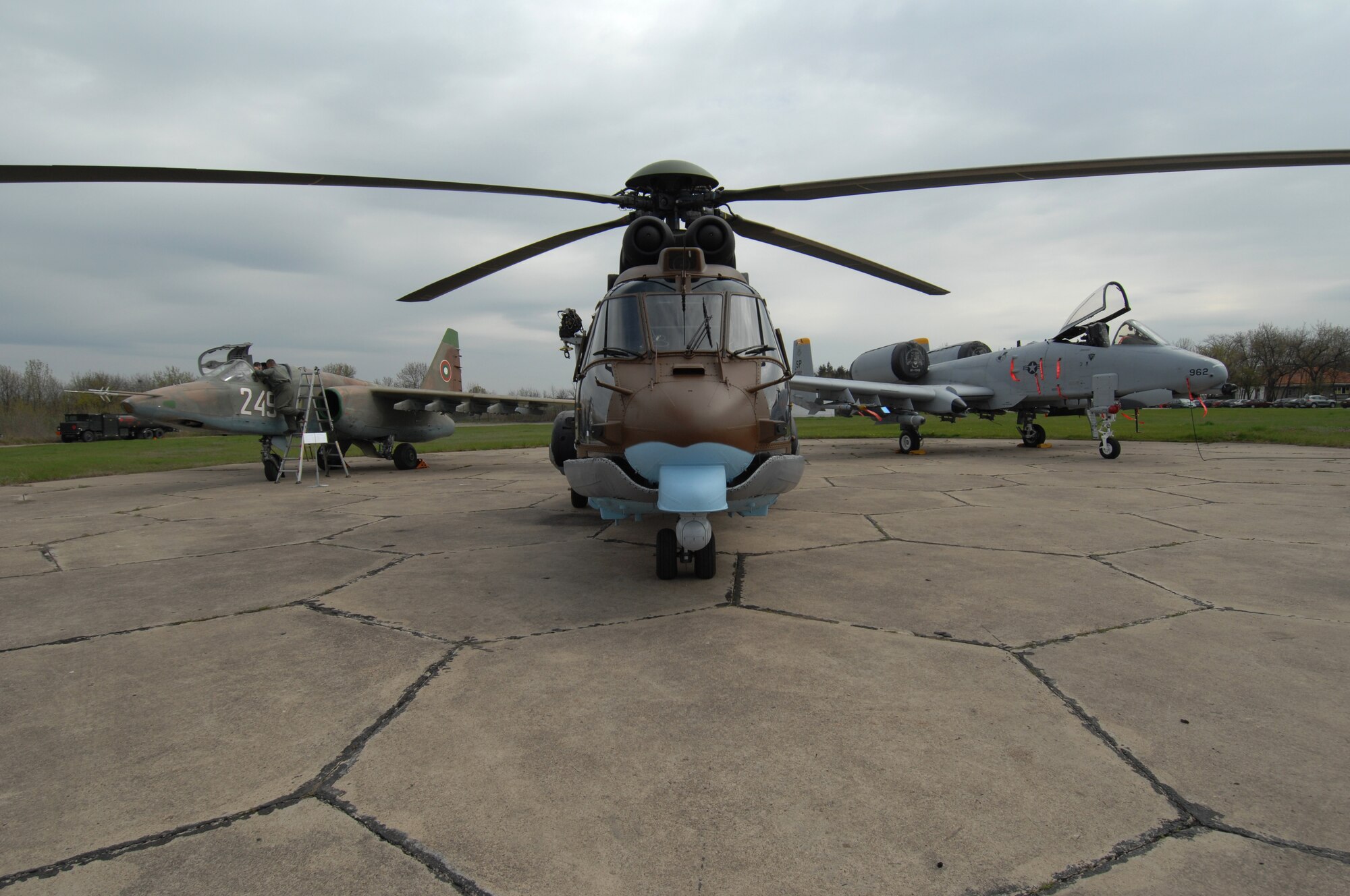 BEZMER AIR BASE, Bulgaria – (From Left to right), A Bulgarian SU-25 Frogfoot fighter aircraft, a Bulgarian AS-532AL Cougar helicopter and a 81st Fighter Squadron A-10 Thuderbolt II are staged on a landing pad in Bezmer Air Base, Bulgaria, in preparation for a base media day April 15, 2009.  (U.S. Air Force photo by Master Sgt. Bill Gomez) 