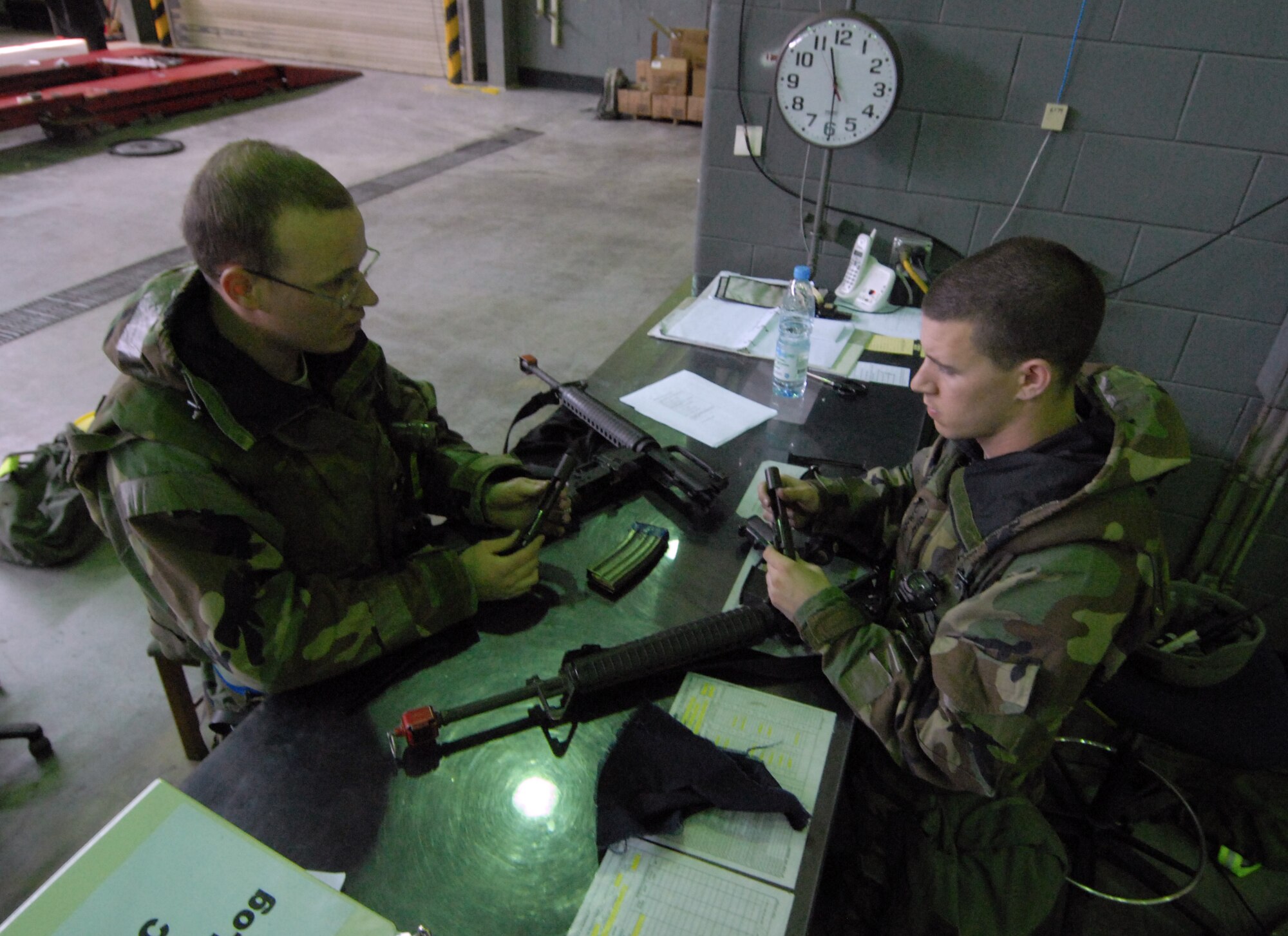 Senior Airmen Jerad Davis and Kyle Salyer, 8th Logistics Readiness Squadron, clean their M-16 rifles during the Pacific Air Forces Operational Readiness Inspection at Kunsan Air Base, Republic of Korea, April 21, 2009. Airmen Davis and Salyer are members of the squadron's Selective Arming team. The SELARM program allows squadrons to provide their own trained and armed Airmen to protect their facilities, enabling security forces Airmen to provide more robust protection to the base. (Photo by Senior Airman Gustavo Gonzalez)
