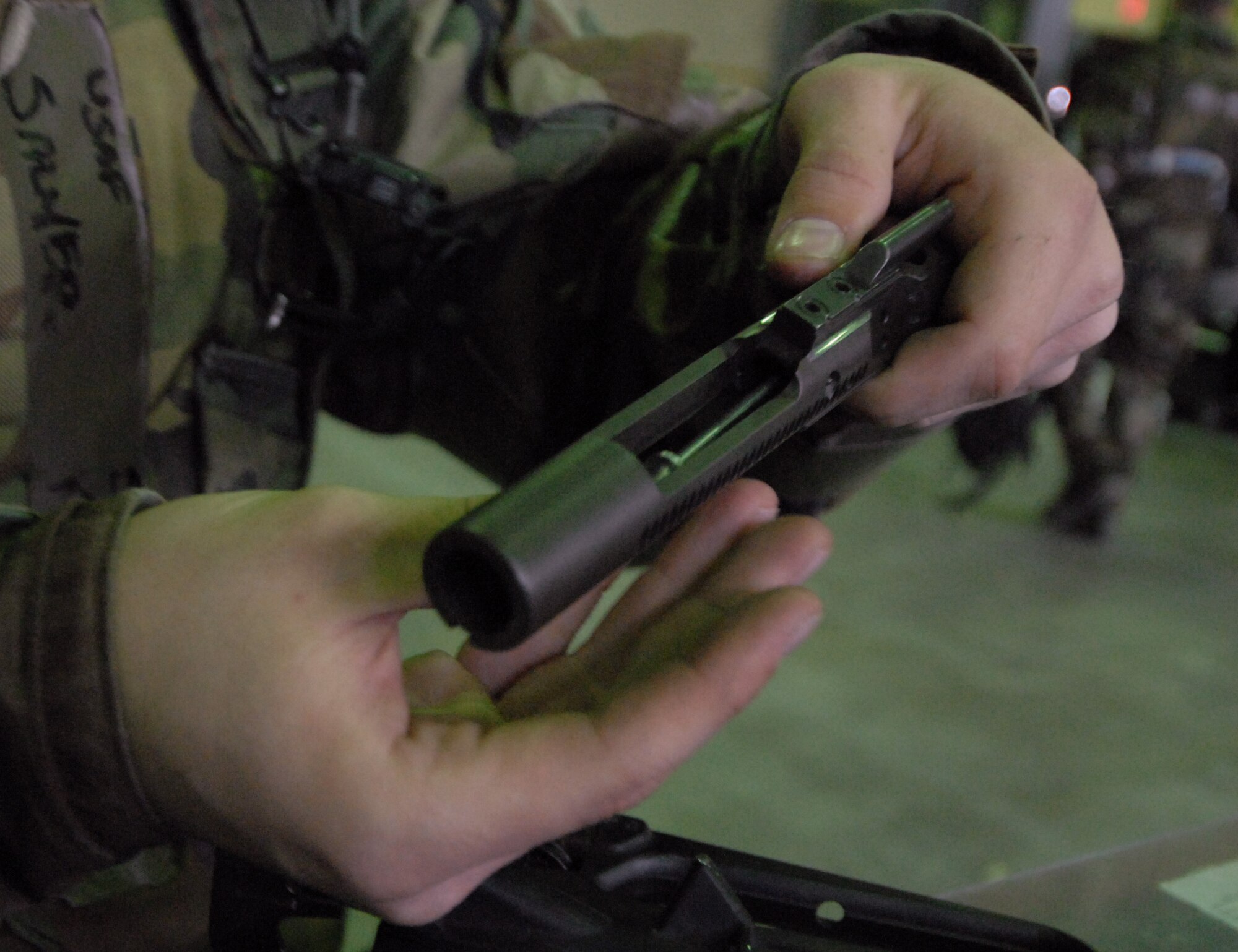 Senior Airman Jerad Davis, 8th Logistic Readiness Squadron, removes the firing pin from the bolt carrier while cleaning his M-16 rifle during the Operational Readiness Inspection at Kunsan Air Base, Republic of Korea, April 21, 2009. Airman Davis is a member of the squadron's Selective Arming team. The SELARM program allows squadrons to provide their own trained and armed Airmen to protect their facilities, enabling security forces Airmen to provide more robust protection to the base. (Photo by Senior Airman Gustavo Gonzalez)
