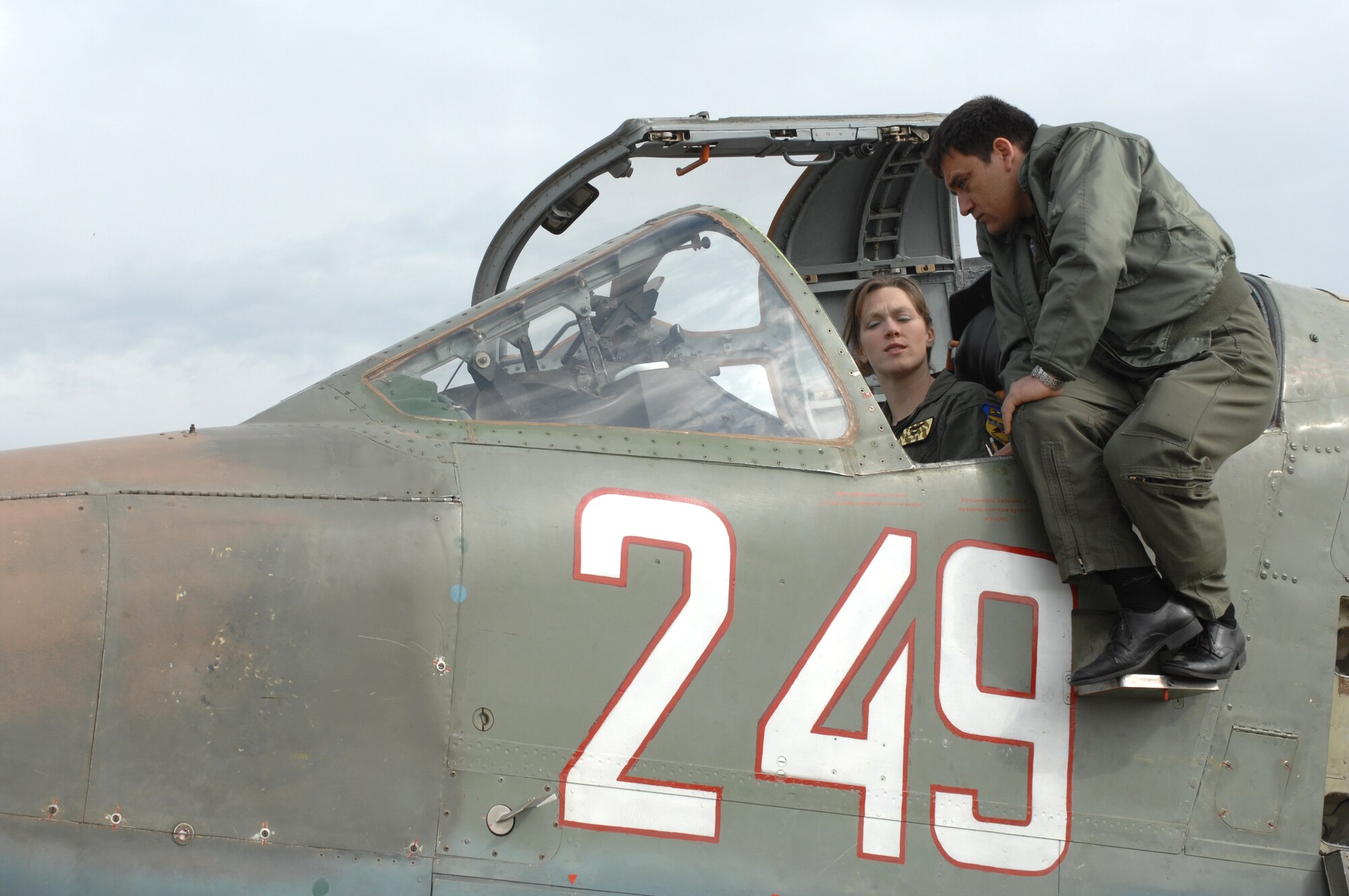 BEZMER AIR BASE, Bulgaria – Capt. Vladislav Todorov, a Bulgarian SU-25 pilot, explains the SU-25 cockpit to 1st Lt. Priscilla Giddings, 81st Fighter Squadron A-10 pilot April 15, 2009. Pilots from the 81st FS and Bulgarian air force jointed together during “Reunion April 2009” to hone their close air support and combat search and rescue capabilities. (U.S. Air Force photo by Master Sgt. Bill Gomez) 