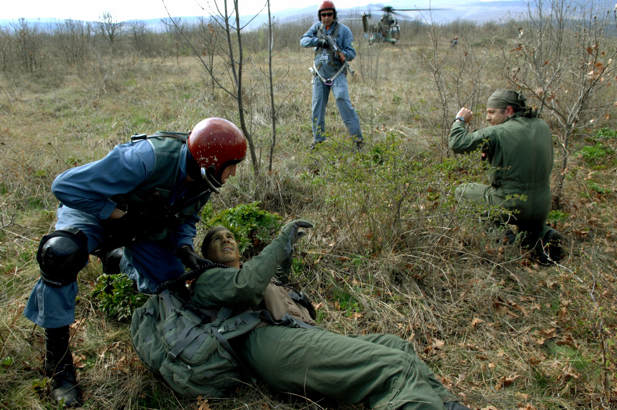 NOVO SELO RANGE, Bulgaria – A Bulgarian AS-532AL Cougar helicopter and its search and rescue team arrive to the aid of simulated downed pilots First Lt. Mike “Vago” Hilkert, 81st Fighter Squadron A-10 pilot, (left) and Capt. Petrov Boislav, a Bulgarian fighter pilot, (right) April 15, 2009.  The scenario was staged in support of “Reunion April 2009,” a joint combat search and rescue training exercise between the U.S. and Bulgarian Air Forces. (U.S. Air Force photo by Master Sgt. Bill Gomez) 