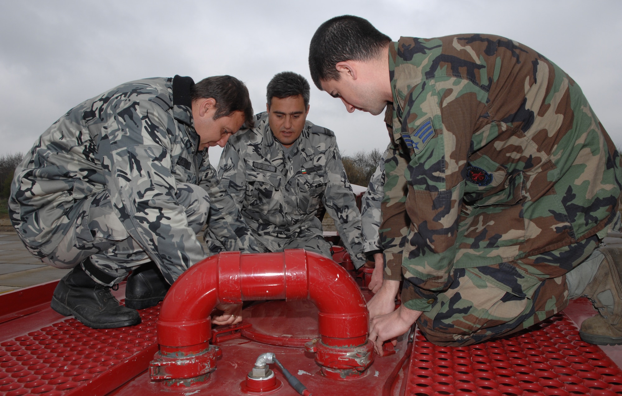 BEZMER AIR BASE, Bulgaria – Senior Airman Spencer K. Lahaie, 52nd Civil Engineer Squadron firefighter, demonstrates features on board a P-19 fire truck to the Bulgarian firefighters.  A six-man fire department team deployed to Bezmer Air Base, Bulgaria, to support “Reunion April 2009,” a joint training exercise. (U.S. Air Force photo by Master Sgt. Bill Gomez) 