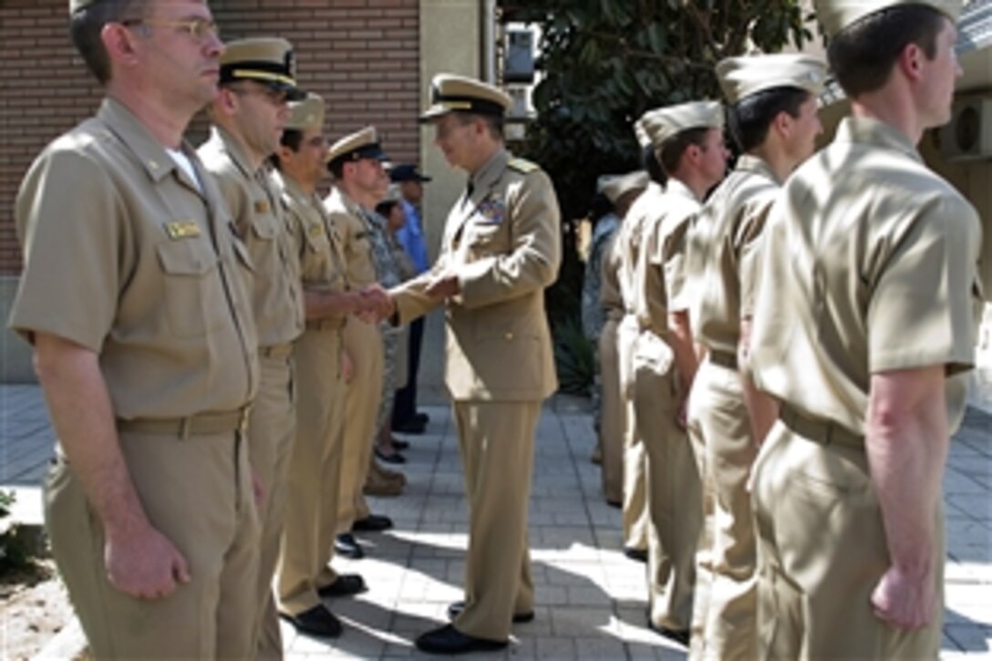 U.S. Navy Adm. Mike Mullen, chairman of the Joint Chiefs of Staff, greets servicemembers assigned to Naval Medical Research Unit in Cairo, Egypt, April 21, 2009. The research unit was founded in the 1940s after a typhus outbreak during the second world war among Egyptian dockworkers. Today, the unit is on the forefront of detecting diseases in developing countries.