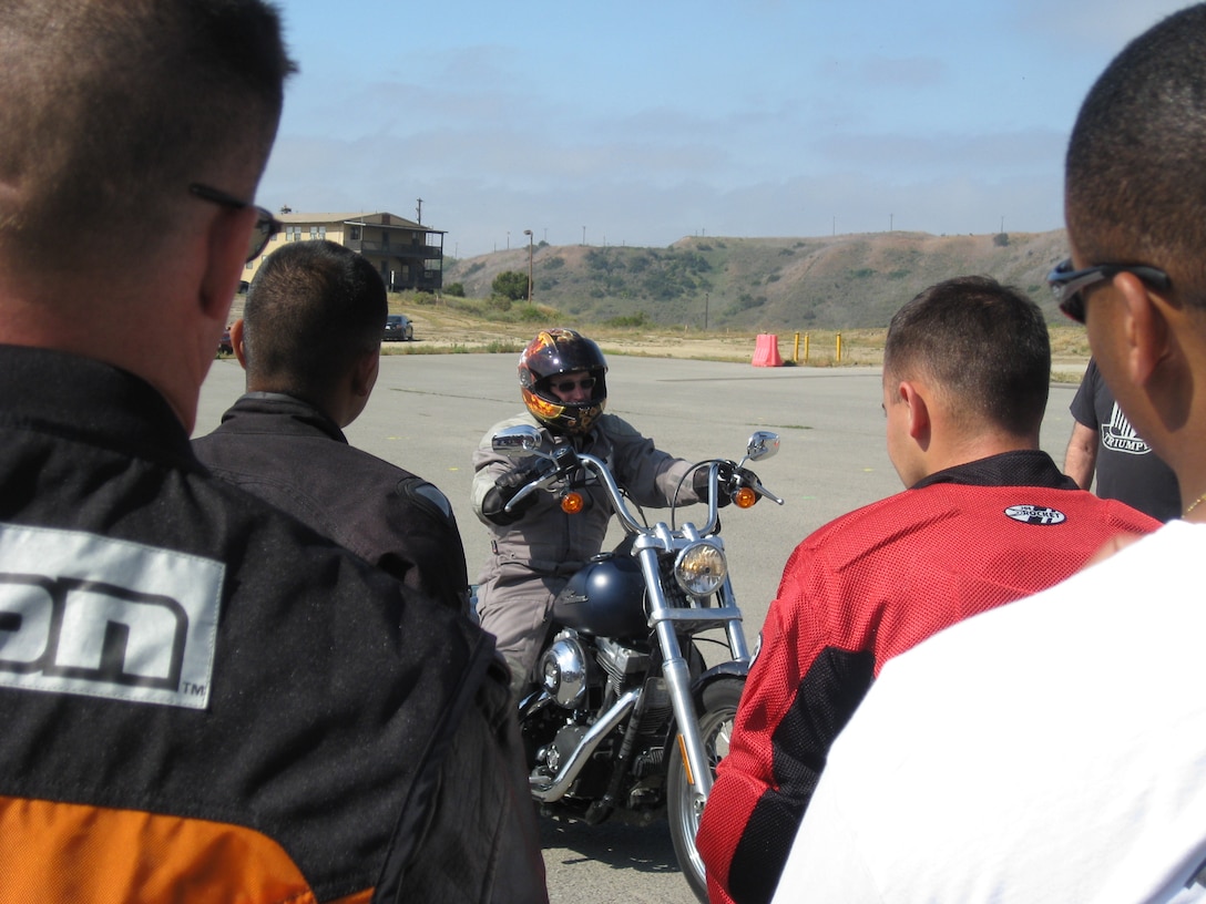 Marines watch as instructor David M. Beyer demonstrates the proper way to clutch, so that Marines can use their motorcycles to their potential and be able to control the amount of torque that the bike gives off.