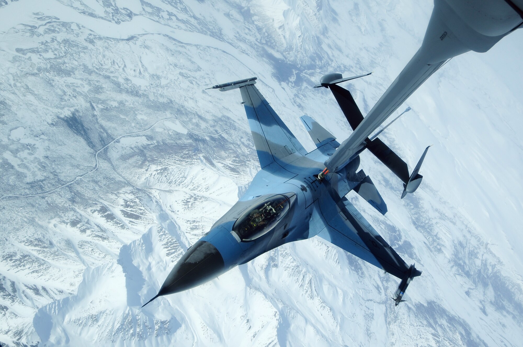 An F-16 Aggressor sits in contact position at 27,000 feet while a KC-10 Extender off-loads fuel during RED FLAG-Alaska 09-2 April 22, 2009, Eielson Air Force Base, Alaska. The Joint Pacific Alaskan Range Complex provides 67,000 square miles of airspace, one conventional bombing range and two tactical bombing ranges containing more than 400 different types of targets and more than 30 threat simulators, both manned and unmanned. The F-16 is assigned to the 18th Aggressor Squadron.  (U.S. Air Force Photo/Senior Airman Jonathan Snyder)