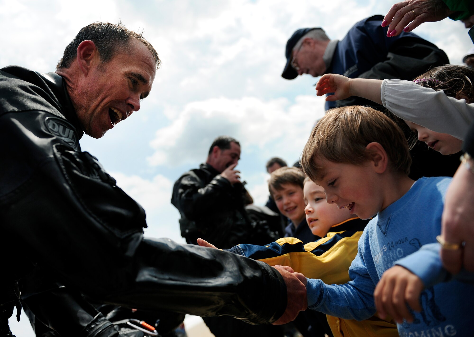 LANGLEY AIR FORCE BASE, Va. --  Master Sgt. Don Currier, 38th Rescue Squadron pararescueman, greets children after at the Virginia Beach boardwalk after jumping from a U.S. Air Force C-130 and swimming ashore April 22.  Sergeant Currier, assigned to Moody Air Force Base, Ga., was part of a joint air power demonstration which also featured F-22, F-15 and Navy F-18 fighter aircraft. (U.S. Air Force photo/Senior Airman Vernon Young)