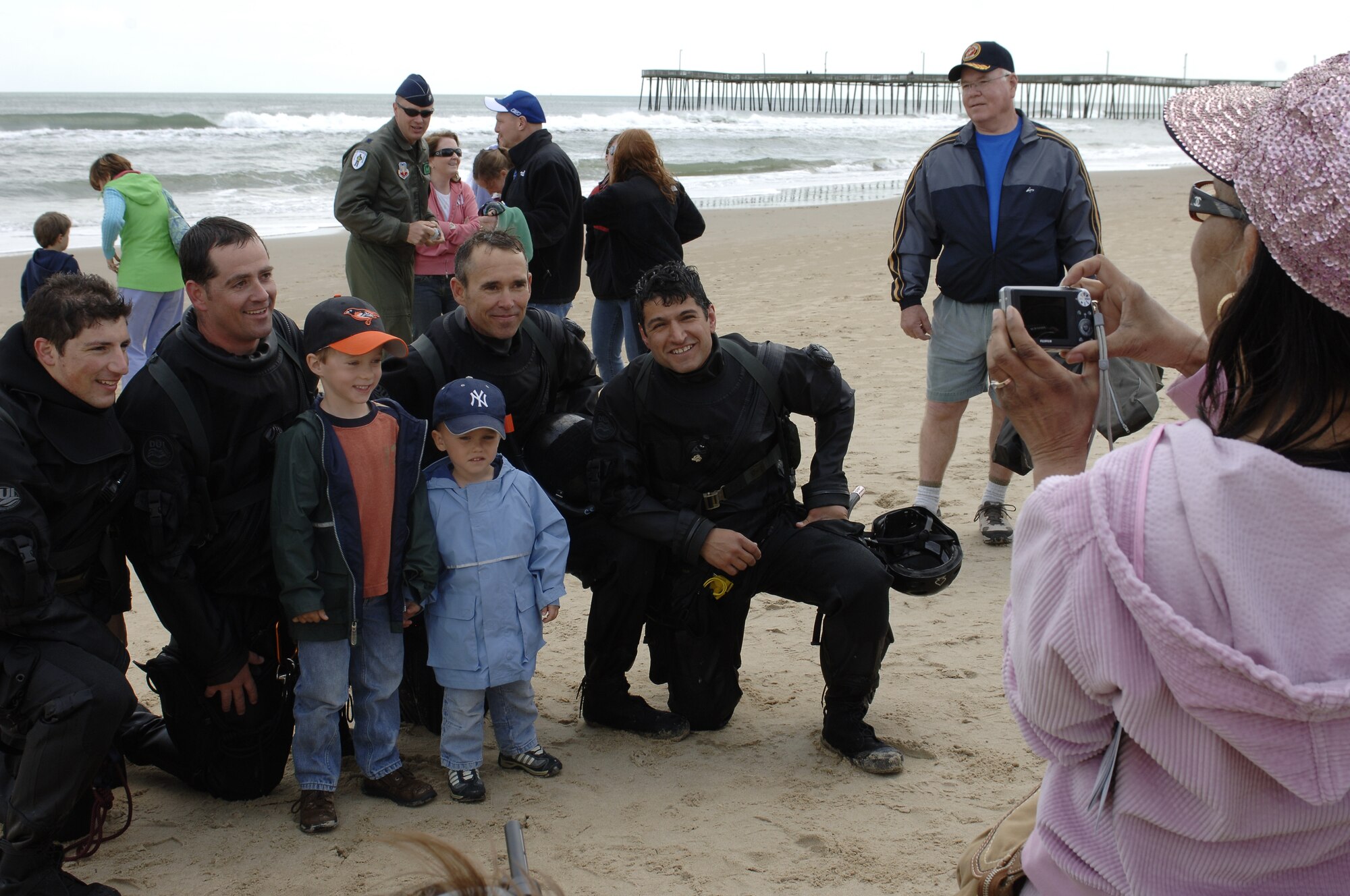 LANGLEY AIR FORCE BASE, Va -- The 38th Rescue Squadron pararescuemen, Moody Air Force Base, Ga., pose for photos with Matthew and Joseph Norman, after completing the Joint Air Power Demonstration at Virginia Beach boardwalk April 22. The demonstration showcased the critical role air power plays in the joint fight. This is one of many events going on in the Hampton Roads area as Air Force members say "thank you" to the community during Hampton Roads Air Force Week. (U.S. Air Force photo/Staff Sgt. Christina M. Styer) 

