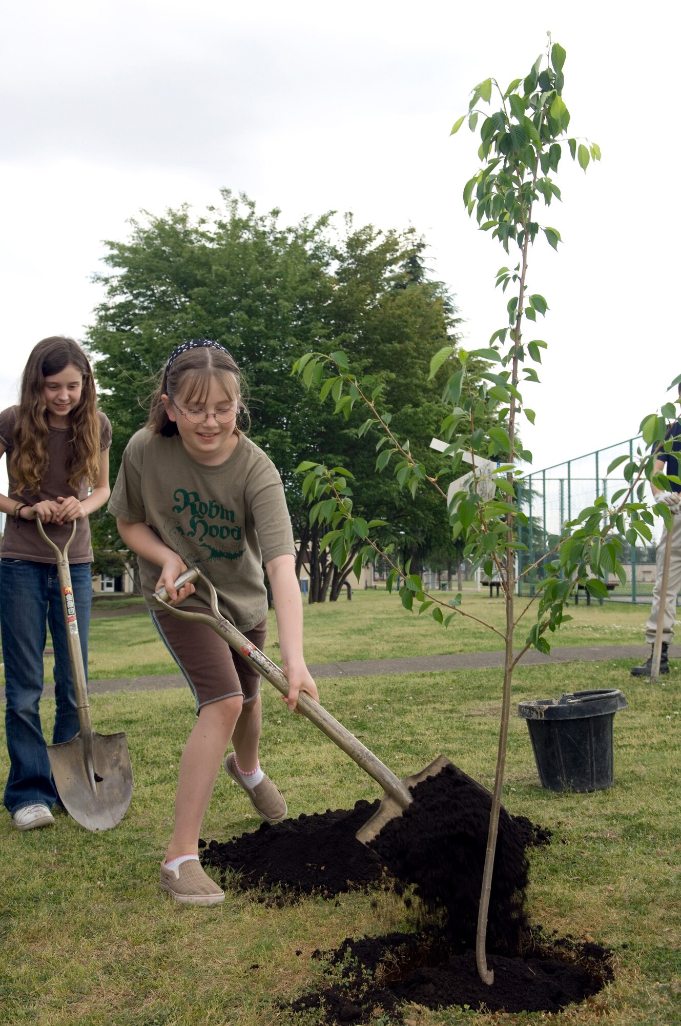 YOKOTA AIR BASE, Japan -- Yokota Middle School student Mireya Ortiz shovels dirt around a Sakura or Japanese cherry tree on the school grounds April 22 to help celebrate Earth Day. First celebrated in 1970, Earth Day is designed to inspire awareness and appreciation for the Earth's environment. (U.S. Air Force photo/Osakabe Yasuo)
