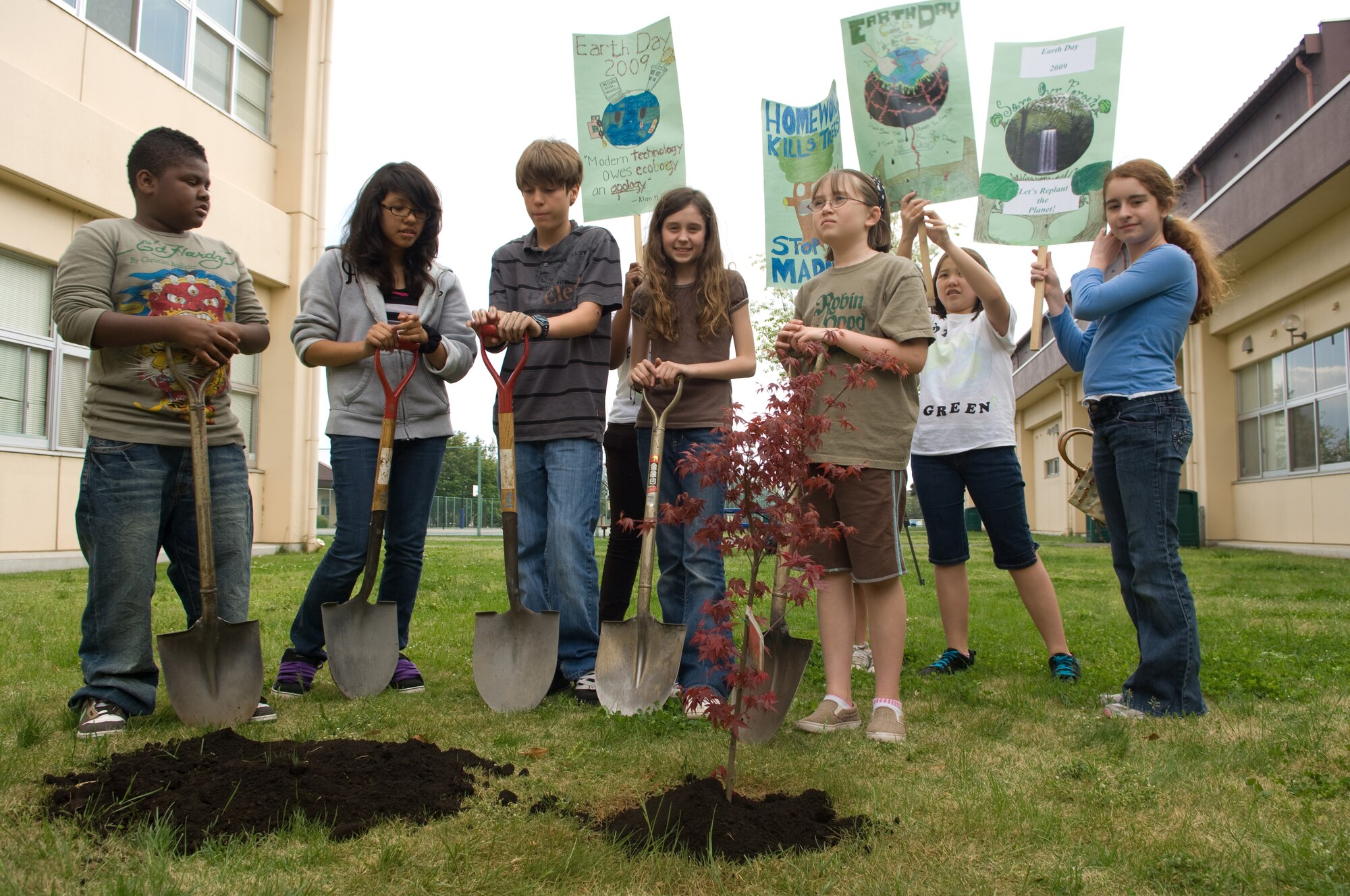 YOKOTA AIR BASE, Japan -- Yokota Middle School students take a moment to reflect on their efforts after planting a Japanese maple on the school grounds April 22 to help celebrate Earth Day. First celebrated in 1970, Earth Day is designed to inspire awareness and appreciation for the Earth's environment. (U.S. Air Force photo/Osakabe Yasuo)