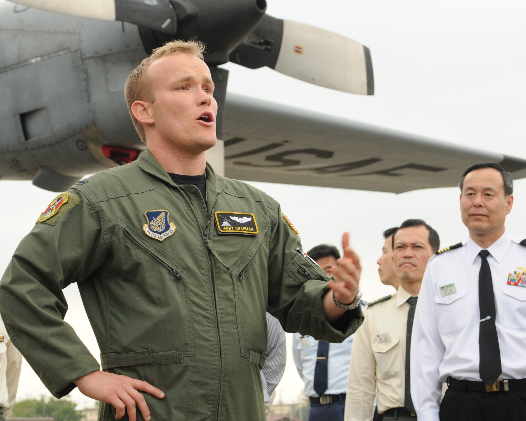 YOKOTA AIR BASE, Japan-- 1st Lt. Andy Chapman, 36th Airlift Squadron, briefs faculty and students from The National Institute for Defense Studies, Japan, April 23 on the squadron's mission and capabilities during a tour of the base flightline. While most of the tour participants were from the Japan Self-Defense Forces, the militaries of France, India, Thailand and the U.S. were represented as well as Japanese civilians who work closely with the military. The purpose of the tour was to deepen the understanding and mission of U.S. Forces Japan in providing security in the Asia and Pacific region. (U.S. Air Force photo/Airman Sean Martin)