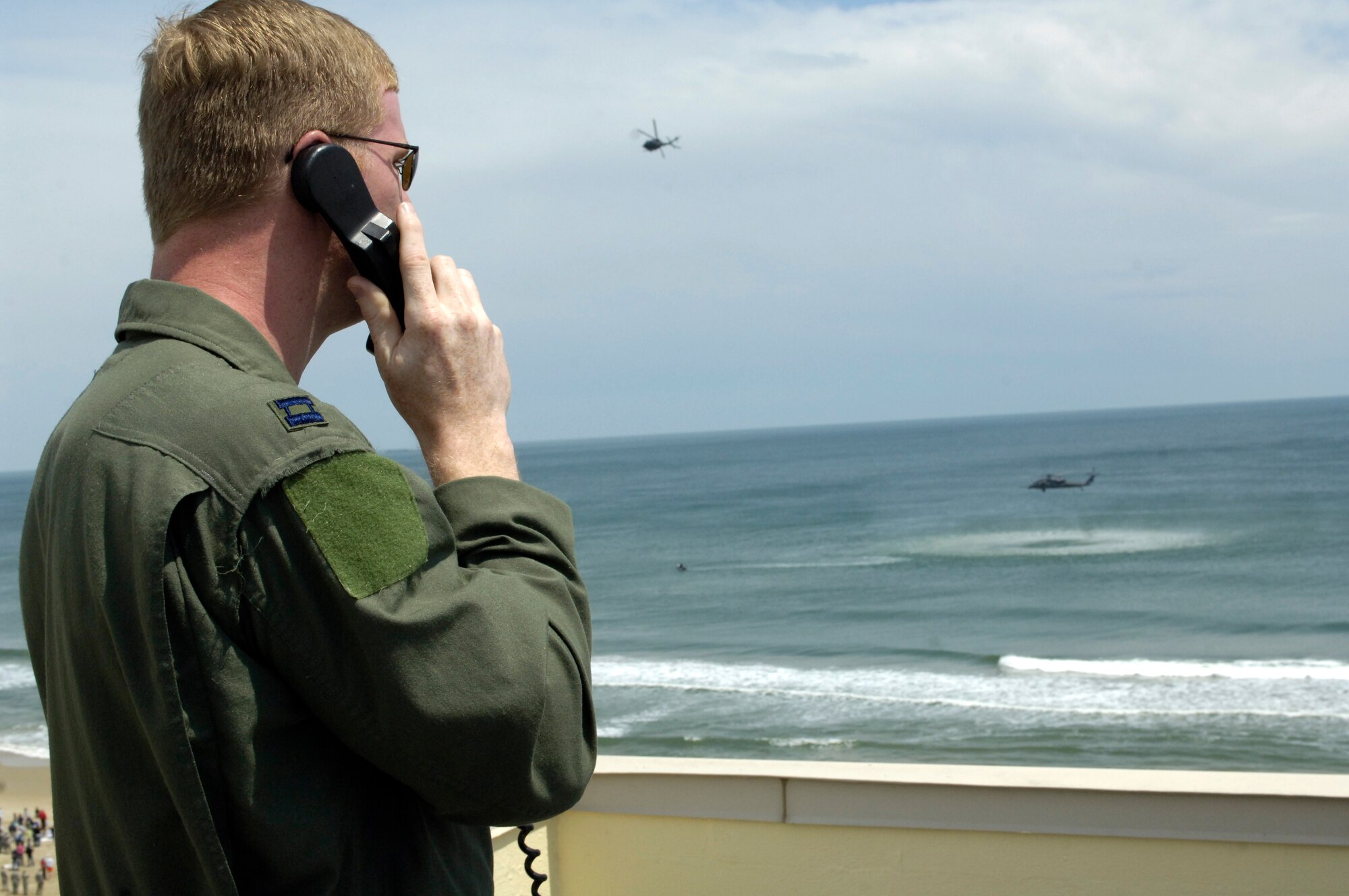 LANGLEY AIR FORCE BASE, Va. -- Capt. Justin Binder, 1st Fighter Wing safety office, oversees air and ground safety during the Joint Air Power Demonstration at the Virginia Beach boardwalk April 22.  The demonstration showcased the critical role air power plays in the joint fight. This is one of many events going on in the Hampton Roads area as the Air Force members say "thank you" to the community during Hampton Roads Air Force Week. (U.S. Air Force photo/Master Sgt. Trish Bunting)