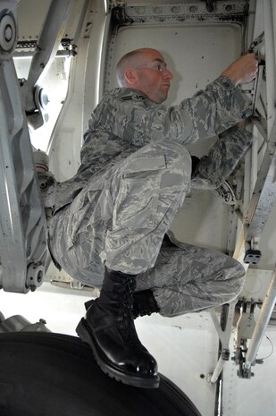 Airman 1st Class Grant Carson prepares to do a voltage check on a C-17 temperature data acquisition unit at Charleston AFB April 22. Under a new base policy, flightline maintenance is one of the authorized industrial areas where Charleston Airmen can wear black boots with their Airman Battle Uniforms. Airman Carson works as a crew chief for the 437th Aircraft Maintenance Squadron. (U.S. Air Force photo/James M. Bowman)