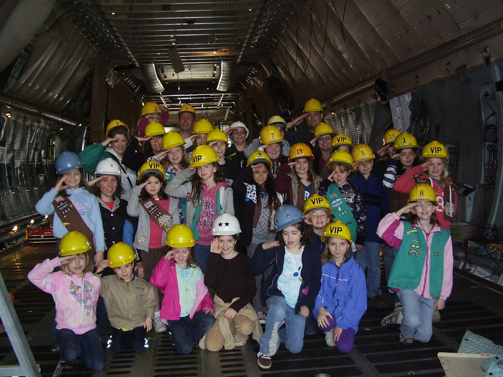 Members of Girl Scouts 392, from Ware, Mass., pause for a photo inside a Westover C-5 Galaxy. The Girl Scouts recently gathered and sent 279 boxes of Girl Scout cookies to service members deployed overseas in Afghanistan, Kuwait, and Iraq. ?Members of the isochronal inspection staff of the 439th Maintenance Squadron, who assisted in coordinating the shipments through the postal service, provided the C-5 tour. (photo by Staff Sgt. Mark McAuliffe)    