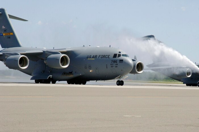 Col. John "Red" Millander taxis through spray from a firetruck April 22 on the flightline after landing at Charleston AFB for his final C-17 flight. Colonel Millander took command of the 437th Airlift Wing in June 2007 and will leave Charleston AFB to become the Chief of the Air Force's Global Mobility Division at the Pentagon. Colonel Millander is currently the 437 AW commander. (U.S. Air Force photo/Staff Sgt. Marie Cassetty)(RELEASED)