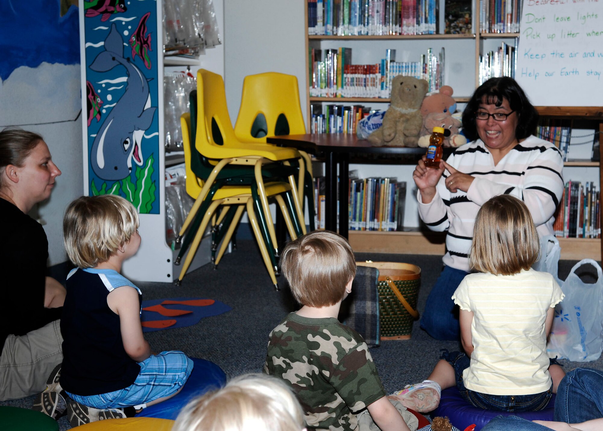 CANNON AIR FORCE BASE, N.M. -- Laretta Croke, a librarian assistant at the Cannon library, reads to children about enviromental contributions they can make to help make the earth cleaner April 21. This event was just one of many Cannon held from April 16-23. There will be another storytelling April 23 at 2 p.m. at the Ranchvale Child Development Center. (U.S. Air Force Photo/Airman 1st Class Danielle Martin)