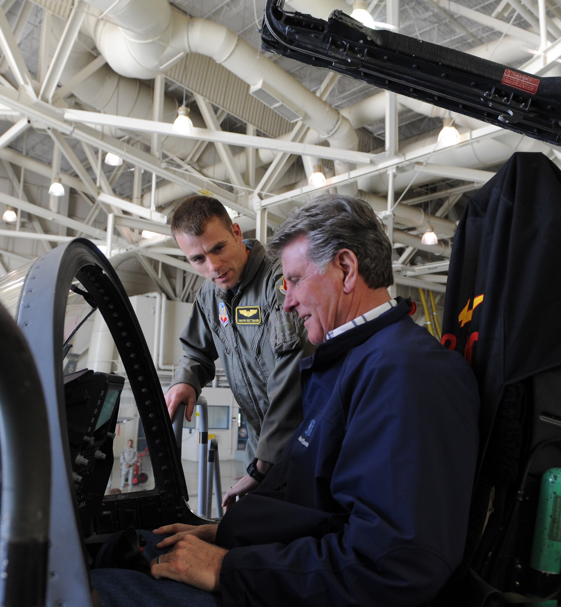 MOUNTAIN HOME AIR FORCE BASE, Idaho – Capt. Crispin Kretzmann, 391st Fighter Squadron, explains the controls in the cockpit of an F-15 to Idaho Gov. C.L. “Butch” Otter during a visit to Mountain Home Air Force Base April 22. Governor Otter visited the 366th Fighter Wing where he received a briefing on the base’s operations and capabilities. This is the first visit by Governor Otter to Mountain Home Air Force Base since he took office. (U.S. Air Force photo / Airman 1st Class Deborah Lockhart)