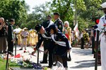 Tech. Sgt. Raymond Rodriguez (left) and Senior Airman Maribelle Hernandez, 2009 Lackland Ambassadors, place red carnations on the Alamo greensward during the Pilgrimage to the Alamo April 20. (U.S. Air Force photo/Frank Estrada) 