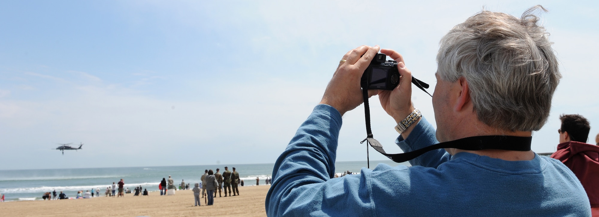 LANGLEY AIR FORCE BASE, Va.  -- Randy Barbee of Gloucester, Va., takes a photograph of a HH-60G Pave Hawk helicopter during the Joint Air Power Demonstration at the Virginia Beach Boardwalk April 22. The demonstration showcased the critical role air power plays in the joint fight. This is one of many events going on in the Hampton Roads area as the Air Force members says “thank you” to the community during Hampton Roads Air Force Week.  (U.S. Air Force photo/Airman 1st Class Gul Crockett) 
