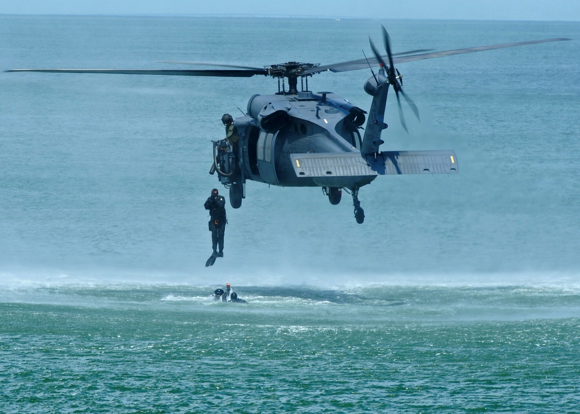 LANGLEY AIR FORCE BASE, Va. -- The 38th Rescue Squadron pararescuemen, Moody Air Force Base, Ga., jump from the 41st Rescue Squadron HH-60G Pave Hawk helicopter, Moody AFB, during the Joint Air Power Demonstration at the Virginia Beach boardwalk April 22. The demonstration showcased the critical role air power plays in the joint fight. This is one of many events going on in Hampton Roads Air Force Week.  (U.S. Air Force photo/Airman 1st Class Jonathan Koob)  