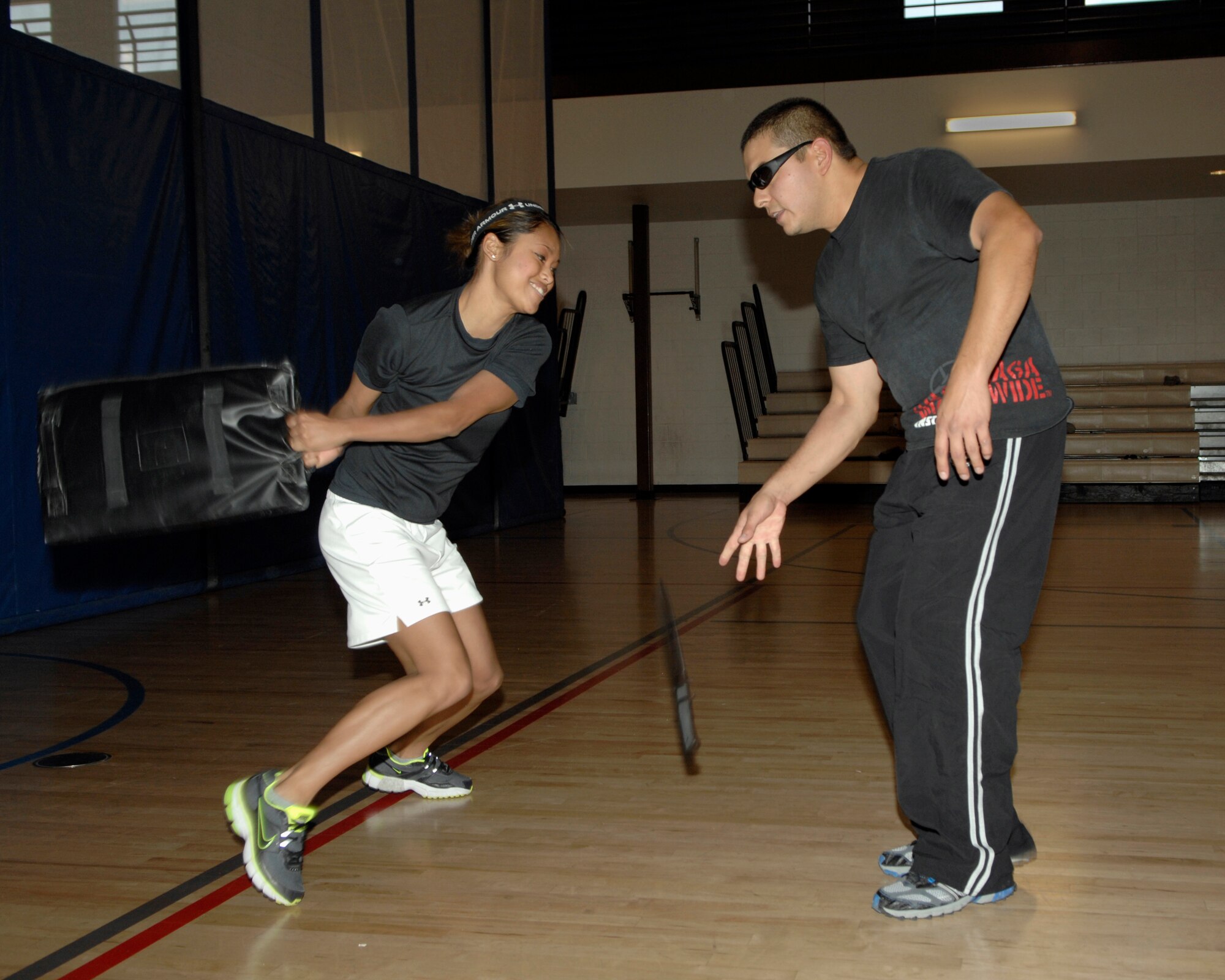 Senior Airman Joyce Geronimo, a fitness specialist from the 355th Force Support Squadron, knocks a plastic knife out of the hand of Albert Garcia, an instructor from Ultima Self Defense & Fitness in Tucson, during a simulated attack at the Benko Fitness Center at Davis-Monthan AFB, Ariz., April 17. Fifteen members of the D-M community participated in a free self-defense class sponsored by the 355th Fighter Wing Sexual Assault Response Coordinator as part of Sexual Assault Awareness Month. (U.S. Air Force photo/1st Lt. Mary Pekas)