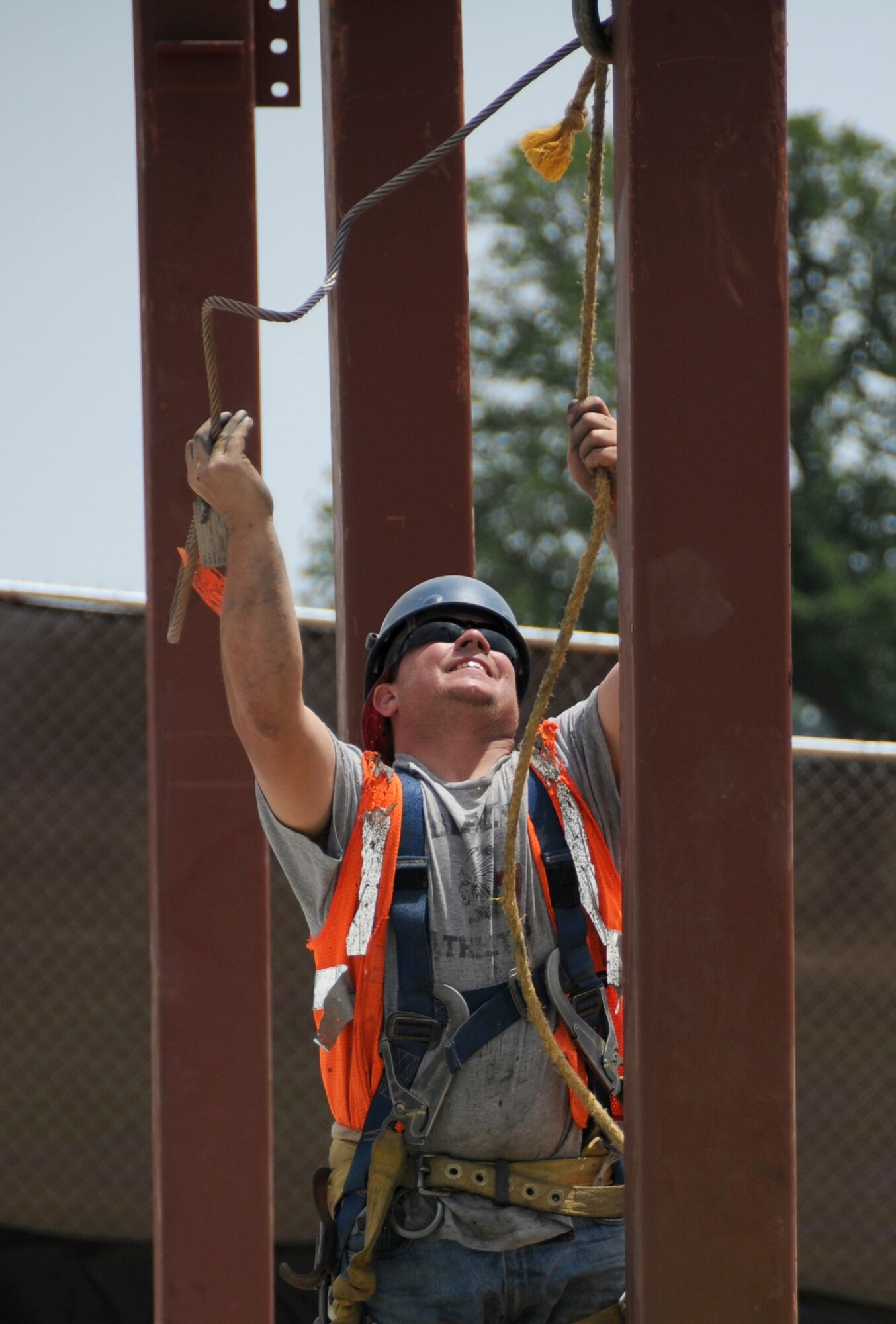 Rodney Stoddard from Ogden Steel Erectors releases a piece of structural steel from the crane hook at the Bay Breeze Events Center construction site.  (U.S. Air Force photo by Kemberly Groue)