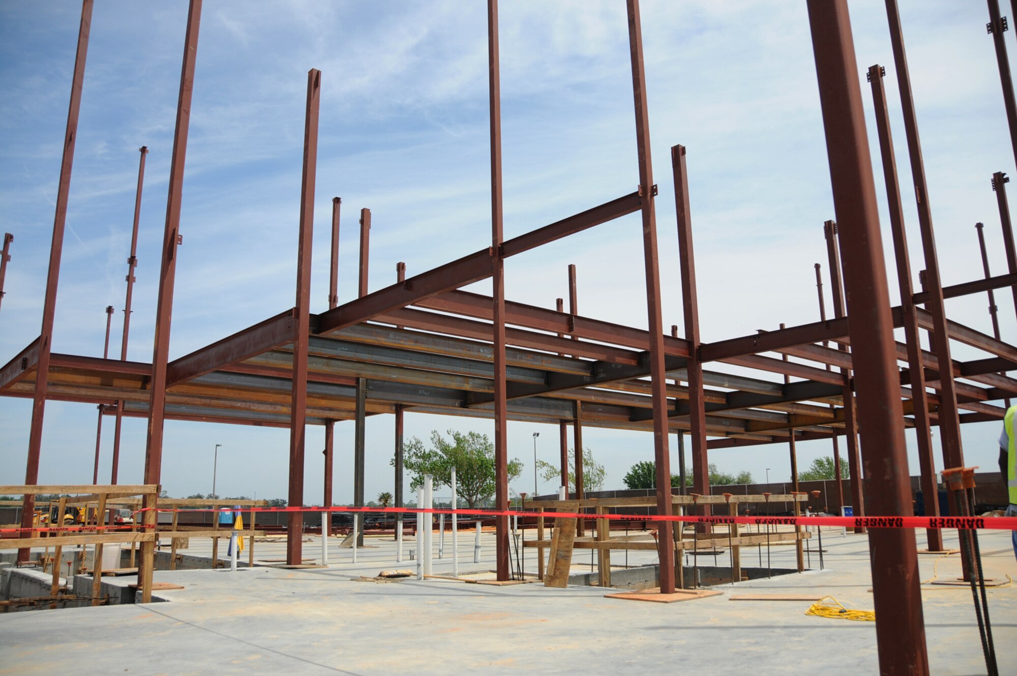 Structural steel is being erected for the east end of the Bay Breeze Events Center which replaces the officer and enlisted clubs and golf course clubhouse slammed by Hurricane Katrina in 2005.  Work is about 28 percent complete on the three-story structure of nearly 66,000 square feet. It will house the golf pro shop, golf cart storage area, a ballroom, several multi-function rooms,  lounges,  kitchen and dining areas, game rooms and music rooms.  The project  required the relocation of a portion of Ploesti Drive, the golf course driving range and extensive parking and drainage alterations.  June 2010 is the estimated completion date for the $26.7 million complex.  (U.S. Air Force photo by Kemberly Groue)