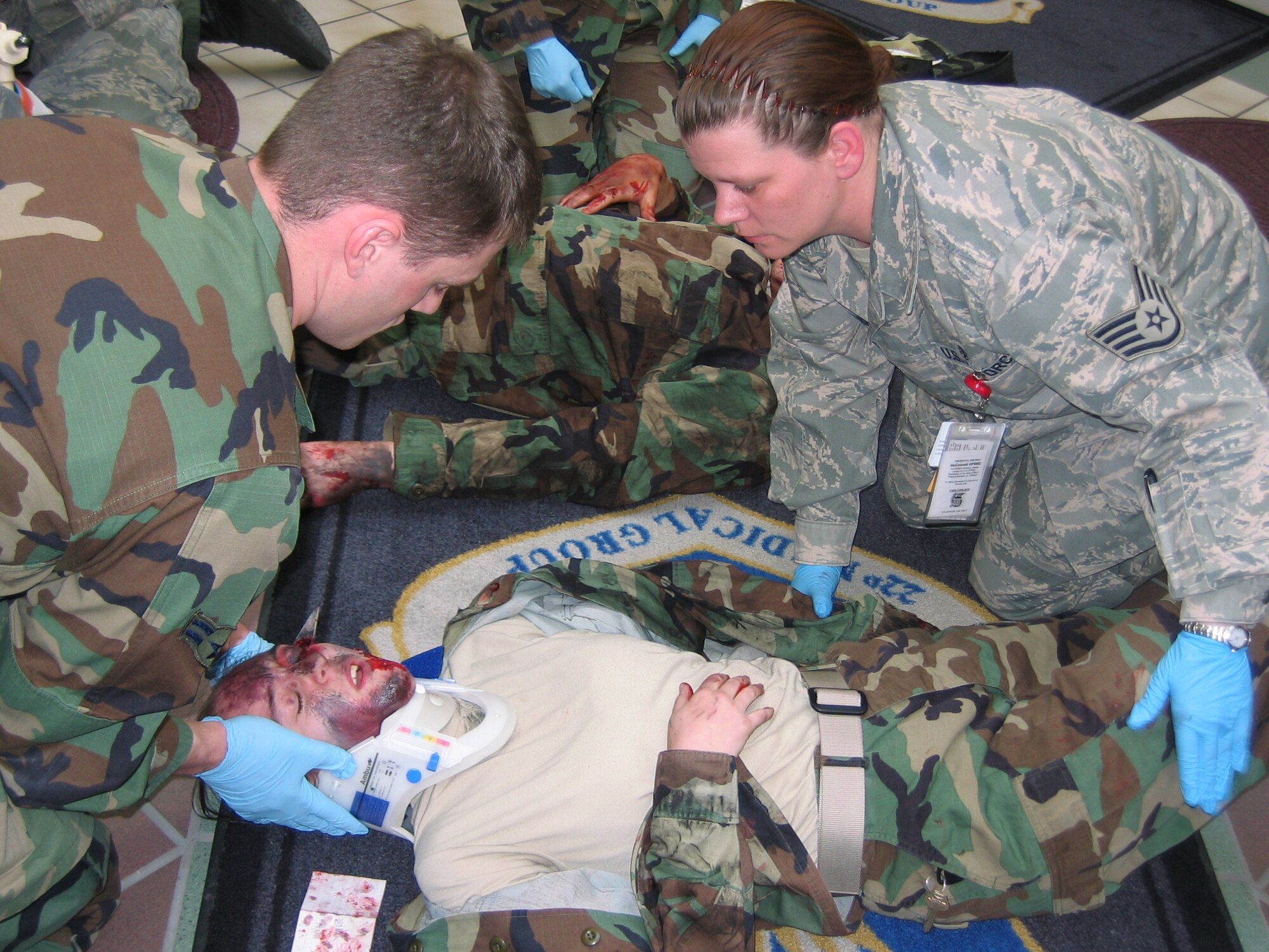 MCCONNELL AIR FORCE BASE, Kan. -- Airman 1st Class Greyson Thompson, 22nd Medical Operations Squadron, and Staff Sgt. Jean Epperson, 22nd Aerospace Medicine Squadron, treat a moulaged volunteer playing the part of a tornado victim during a major accident response exercise on March 10. The event tested McConnell’s preparedness and abilities during a severe weather event. (Photo by Master Sgt. Carissa Parker)